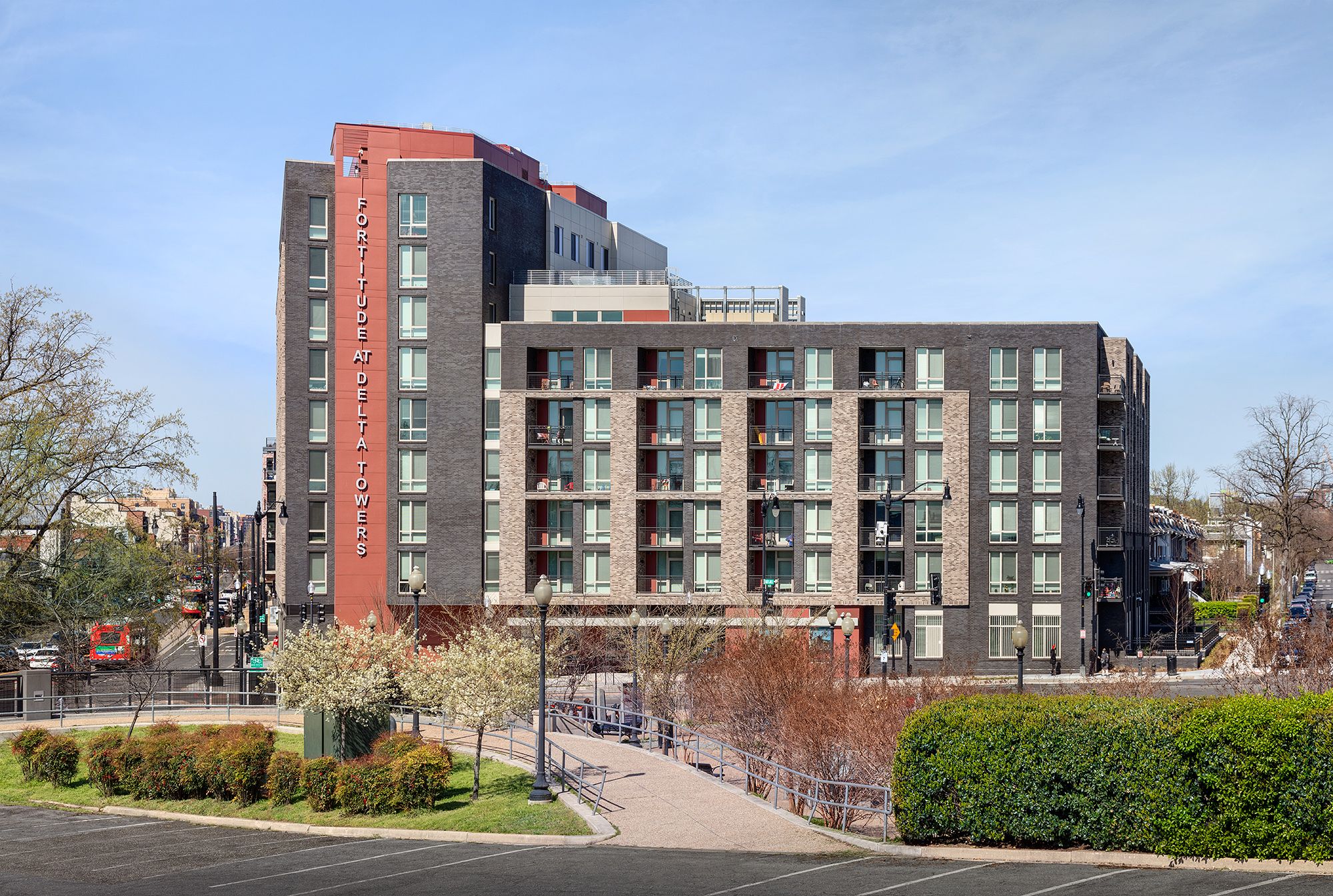 A modern multi-story building with large windows and balconies.