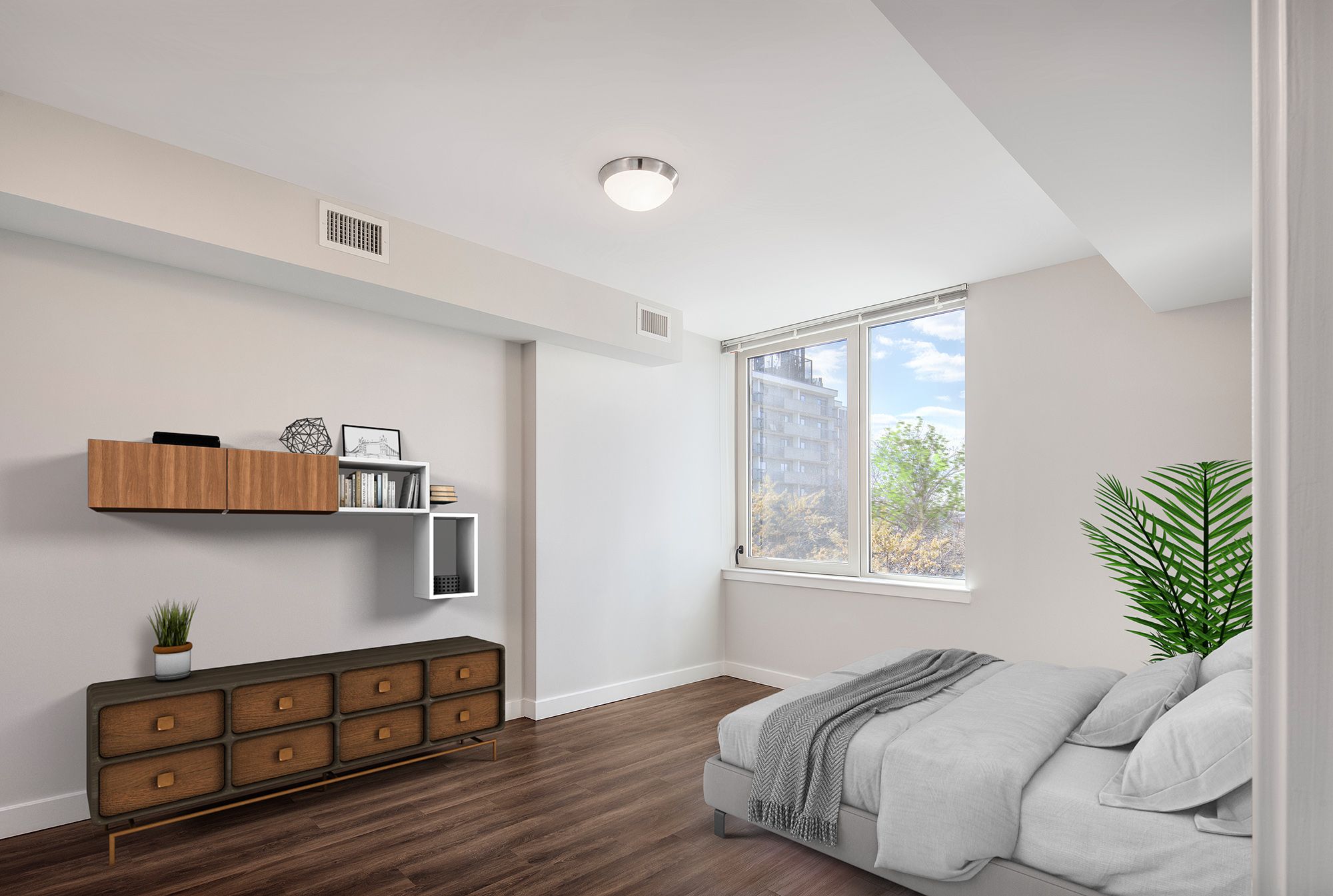 Bright bedroom featuring a bed, wooden furniture, and a window with city views.