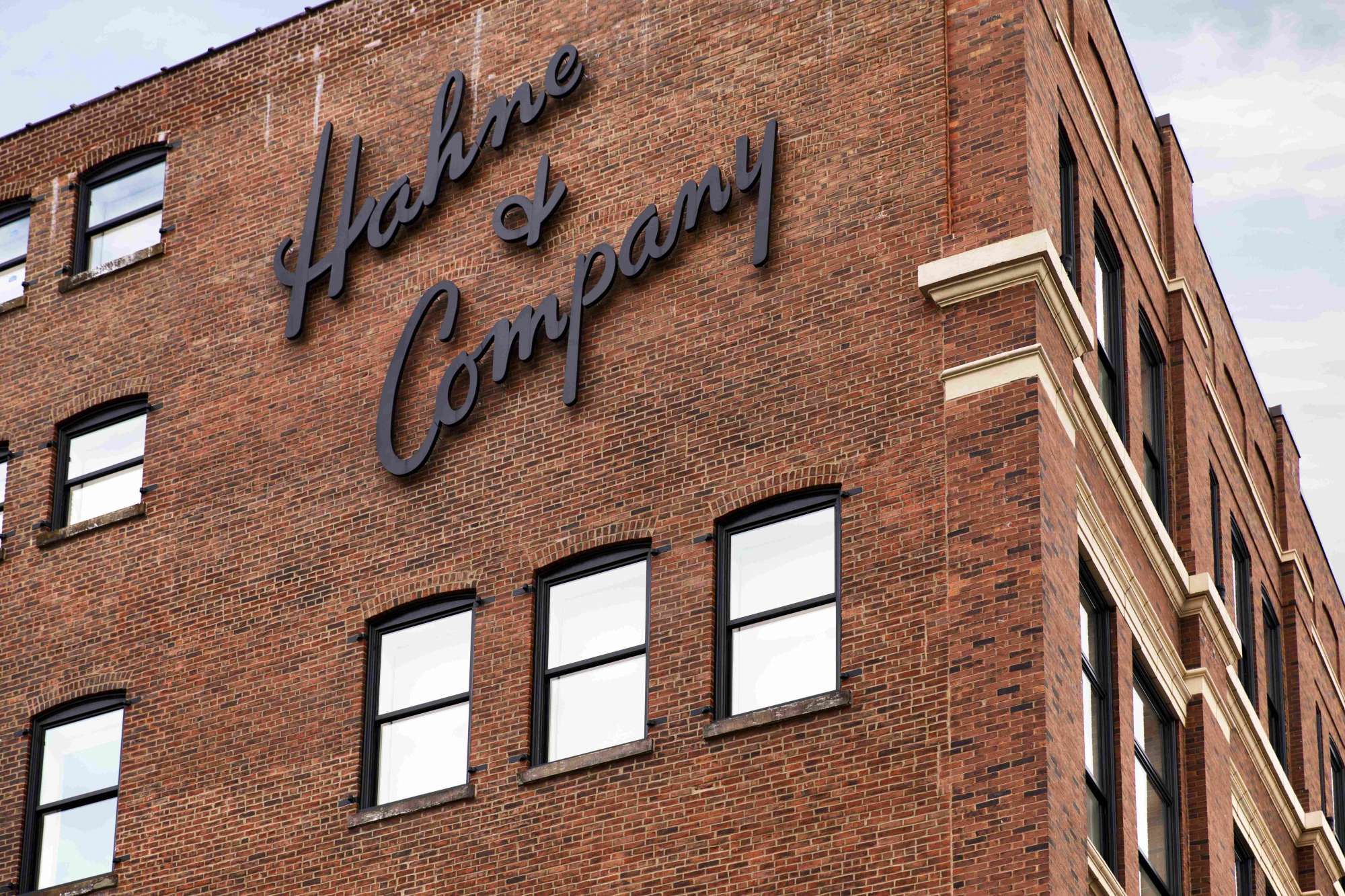 Brick building with "Helme & Company" sign and multiple windows.