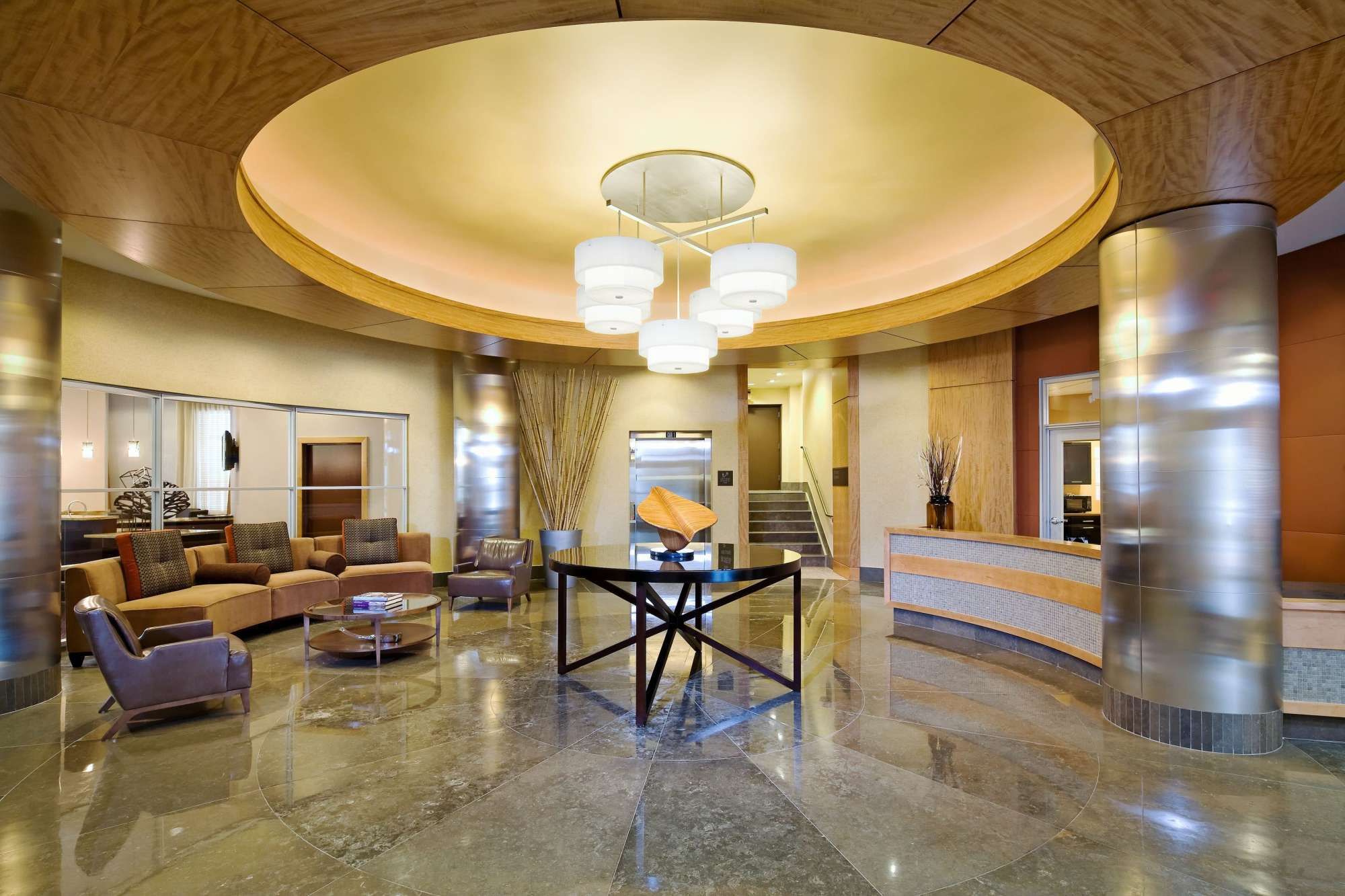 Modern hotel lobby with elegant lighting, comfortable seating, and a welcoming reception area.
