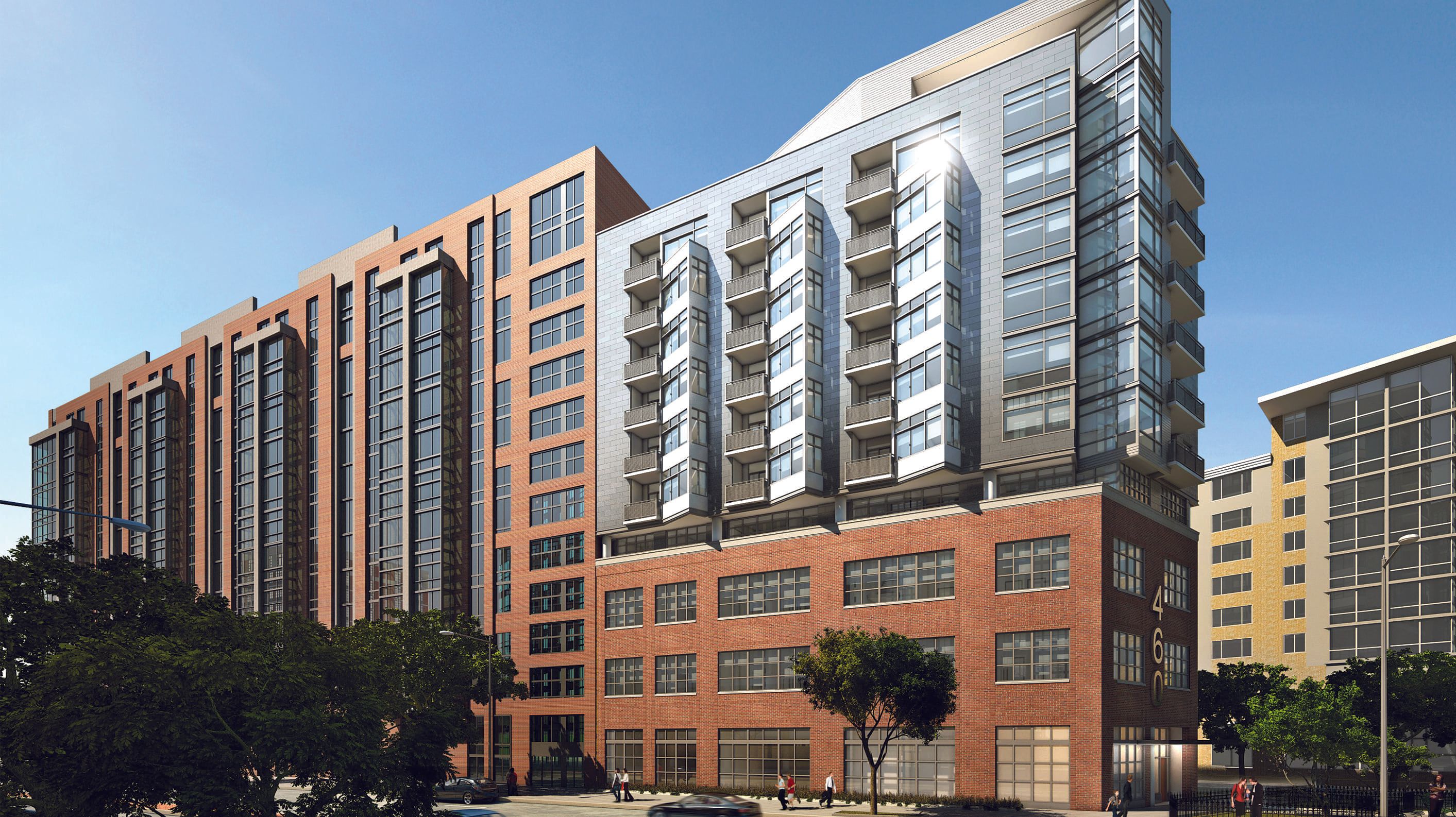 Modern residential building with a mix of brick and glass architecture against a clear sky.