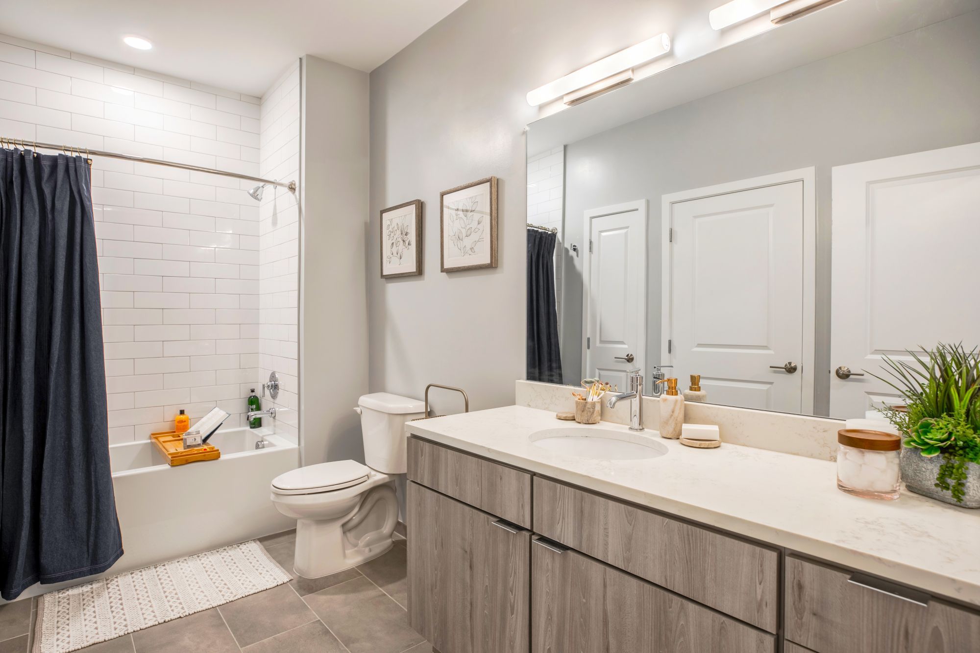 Modern bathroom with a bathtub, vanity, and neutral tones.