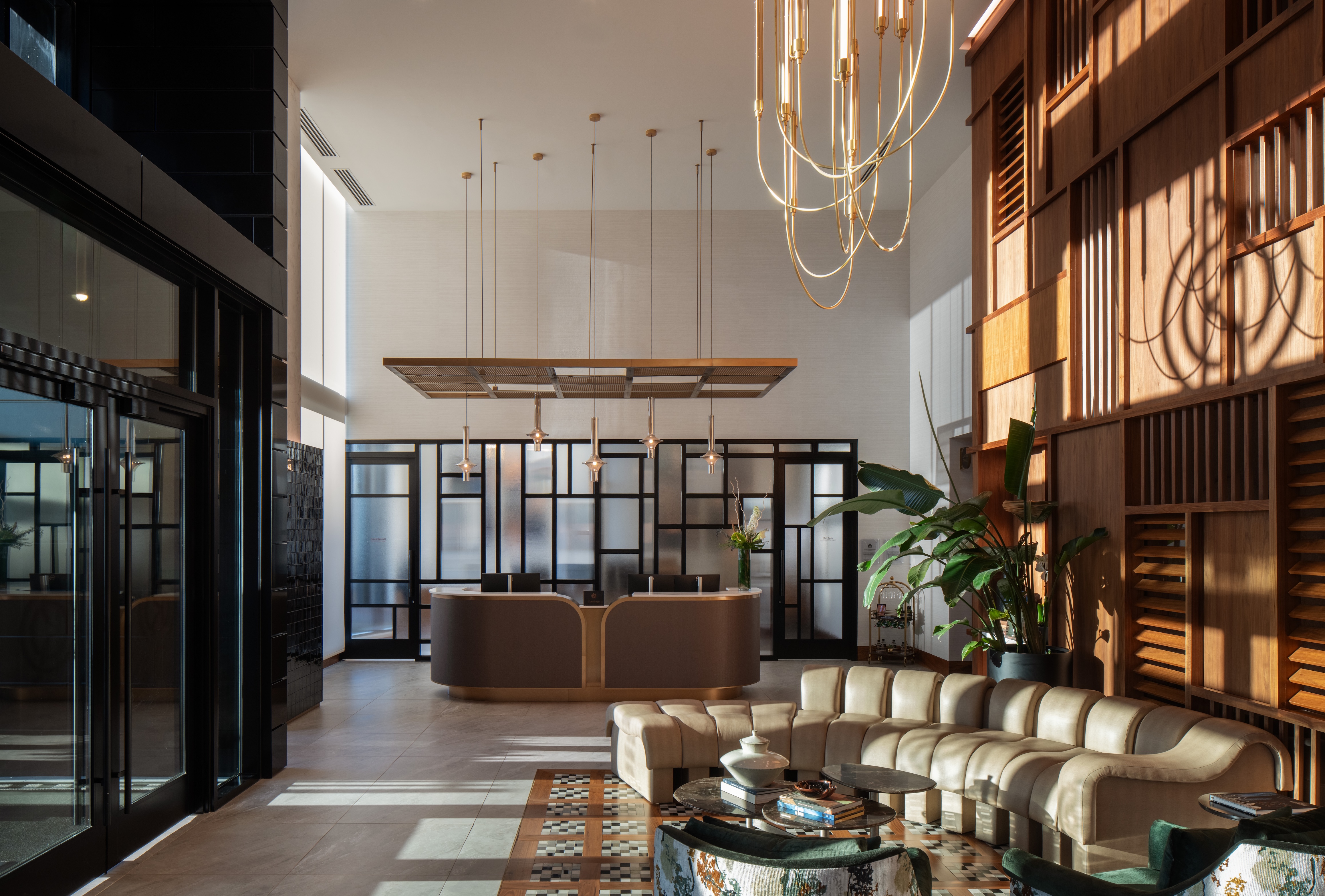 Modern lobby with large windows, elegant seating, and stylish decor.