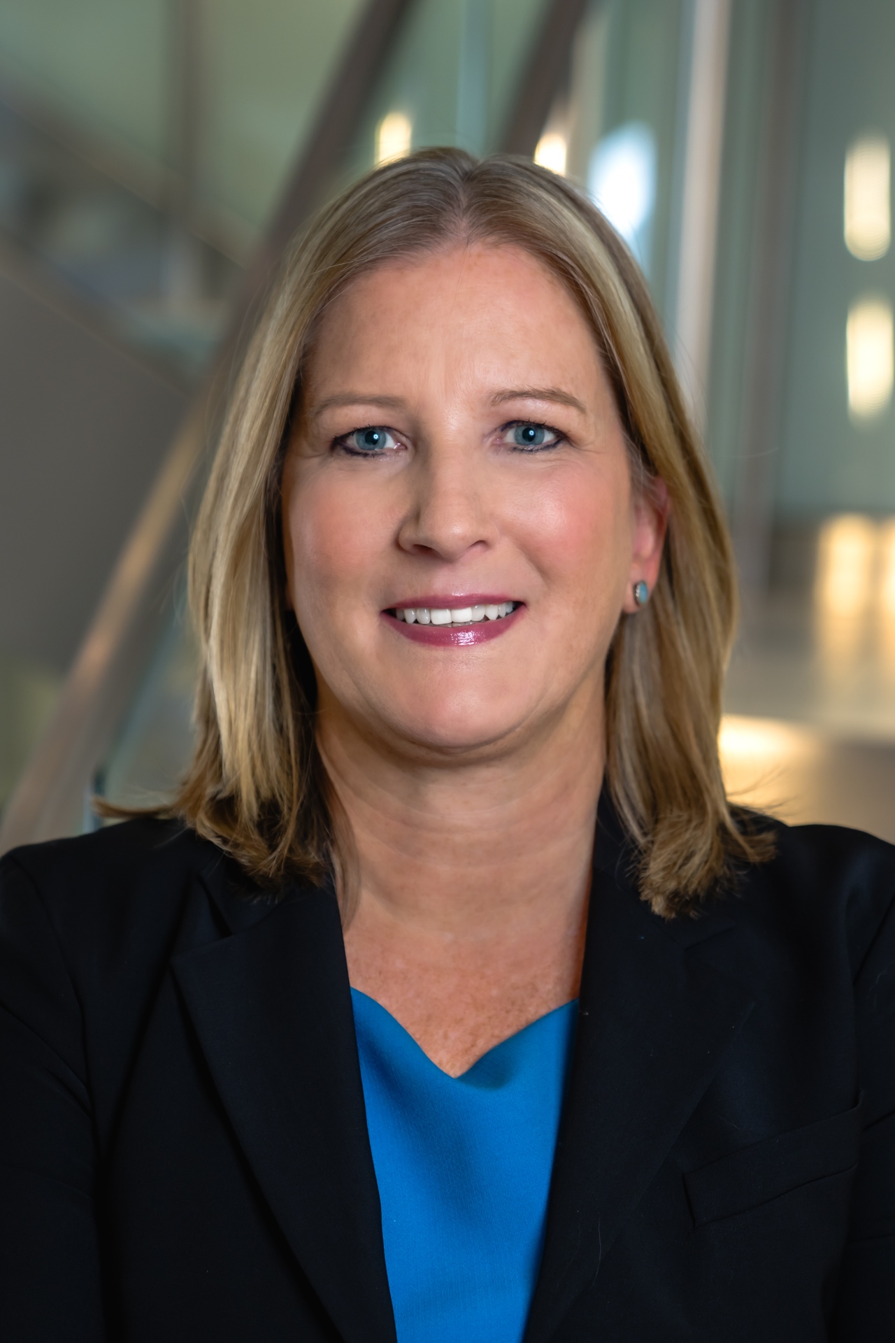 Professional portrait of Audra Vernier, featuring a smiling woman with medium-length hair.