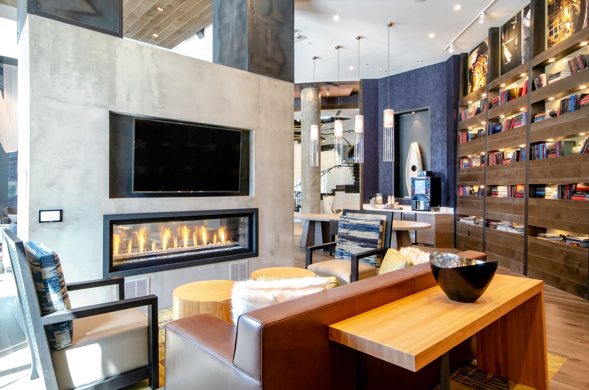 Modern interior with a fireplace, sleek furniture, and a stylish bookshelf.