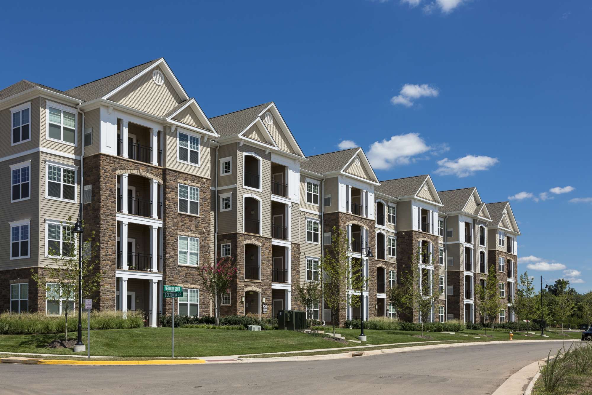 Row of modern apartment buildings under a clear blue sky.