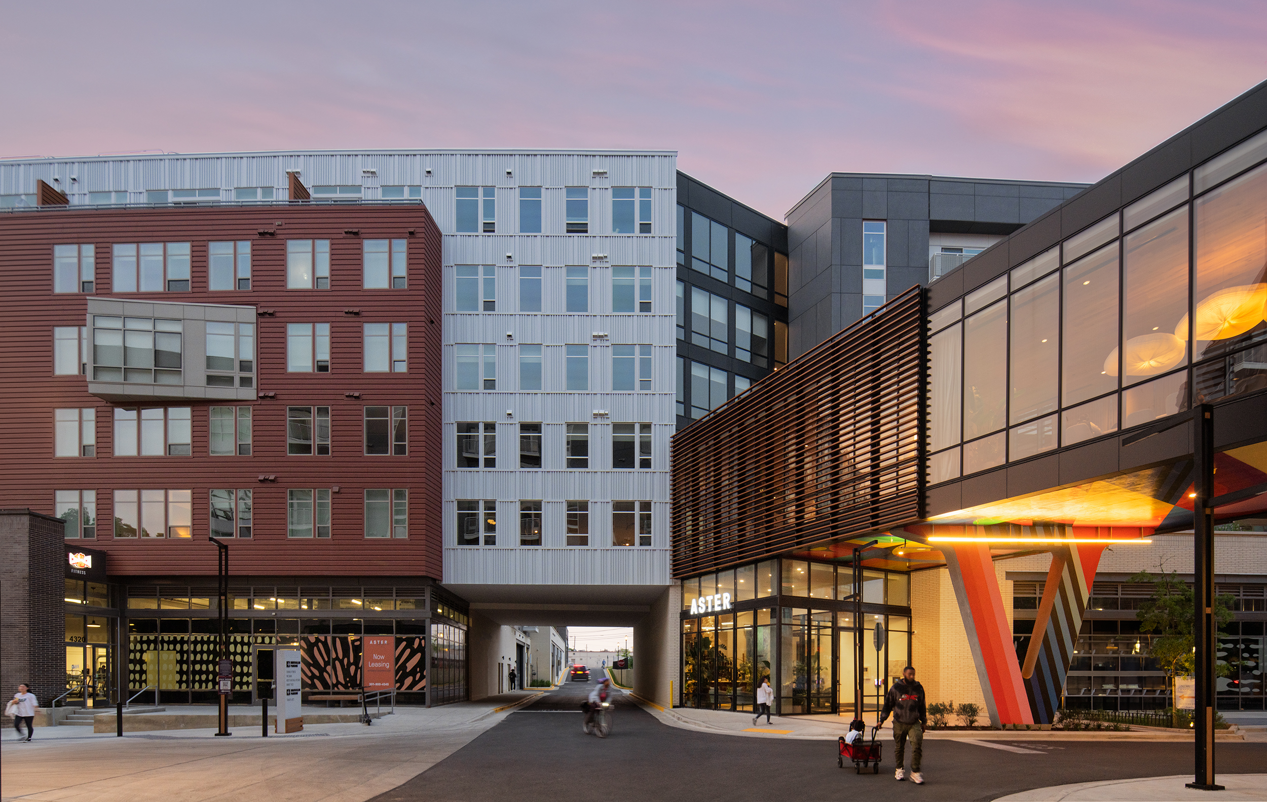Modern buildings with large glass windows at sunset.