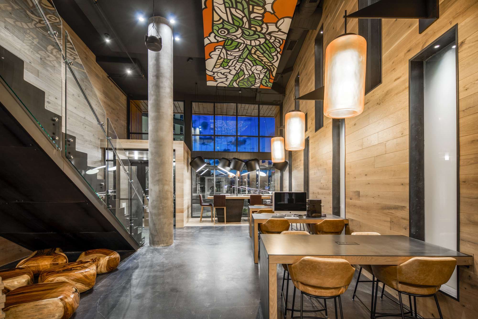 Modern interior featuring wood accents, large windows, and stylish lighting.