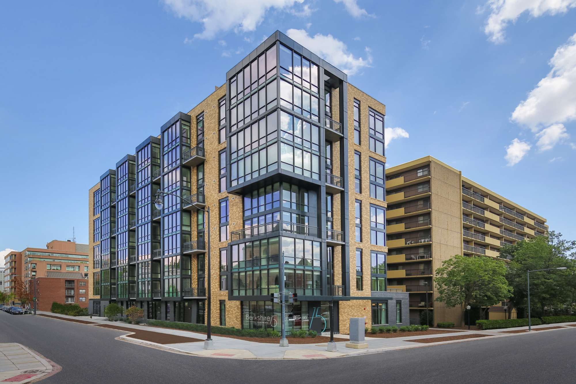 Modern multi-story building with large glass windows on a sunny day.