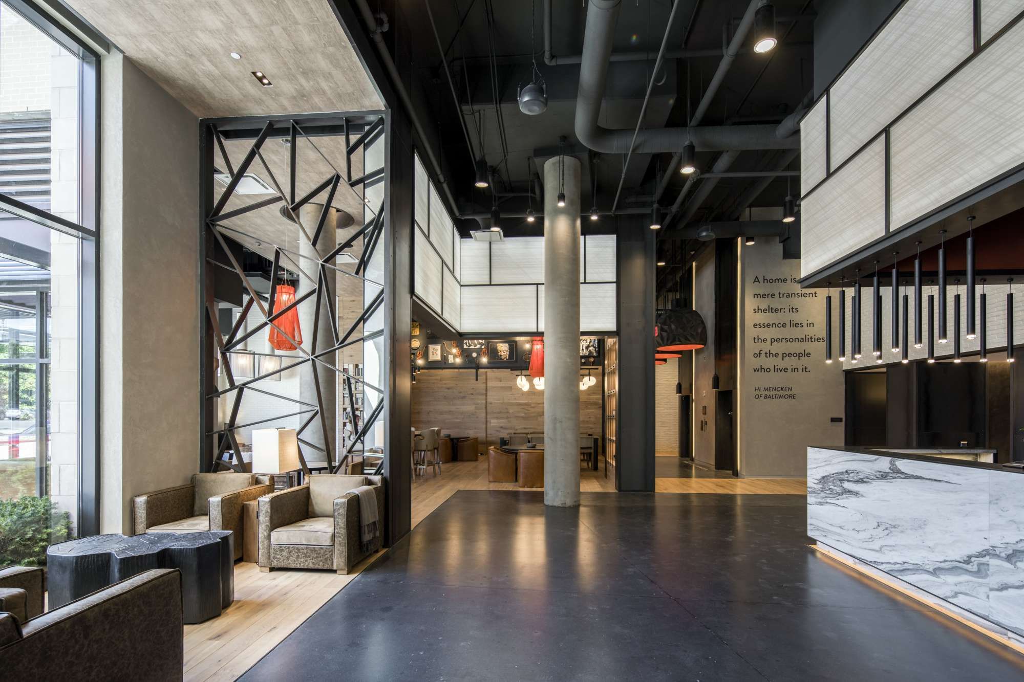 Modern interior of a spacious lobby with sleek furniture and industrial design elements.
