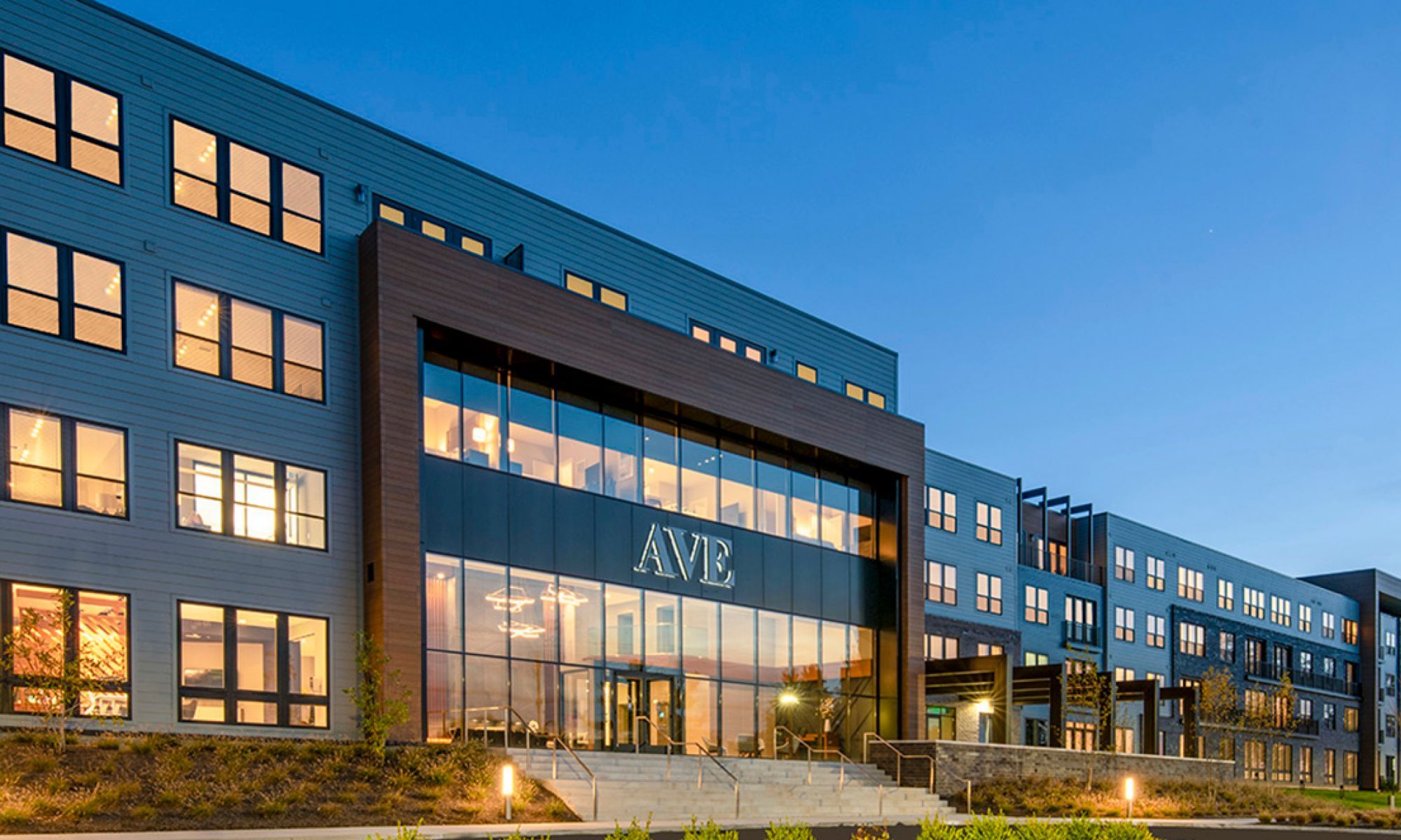 Modern building exterior with large windows and the word "AVE" prominently displayed.