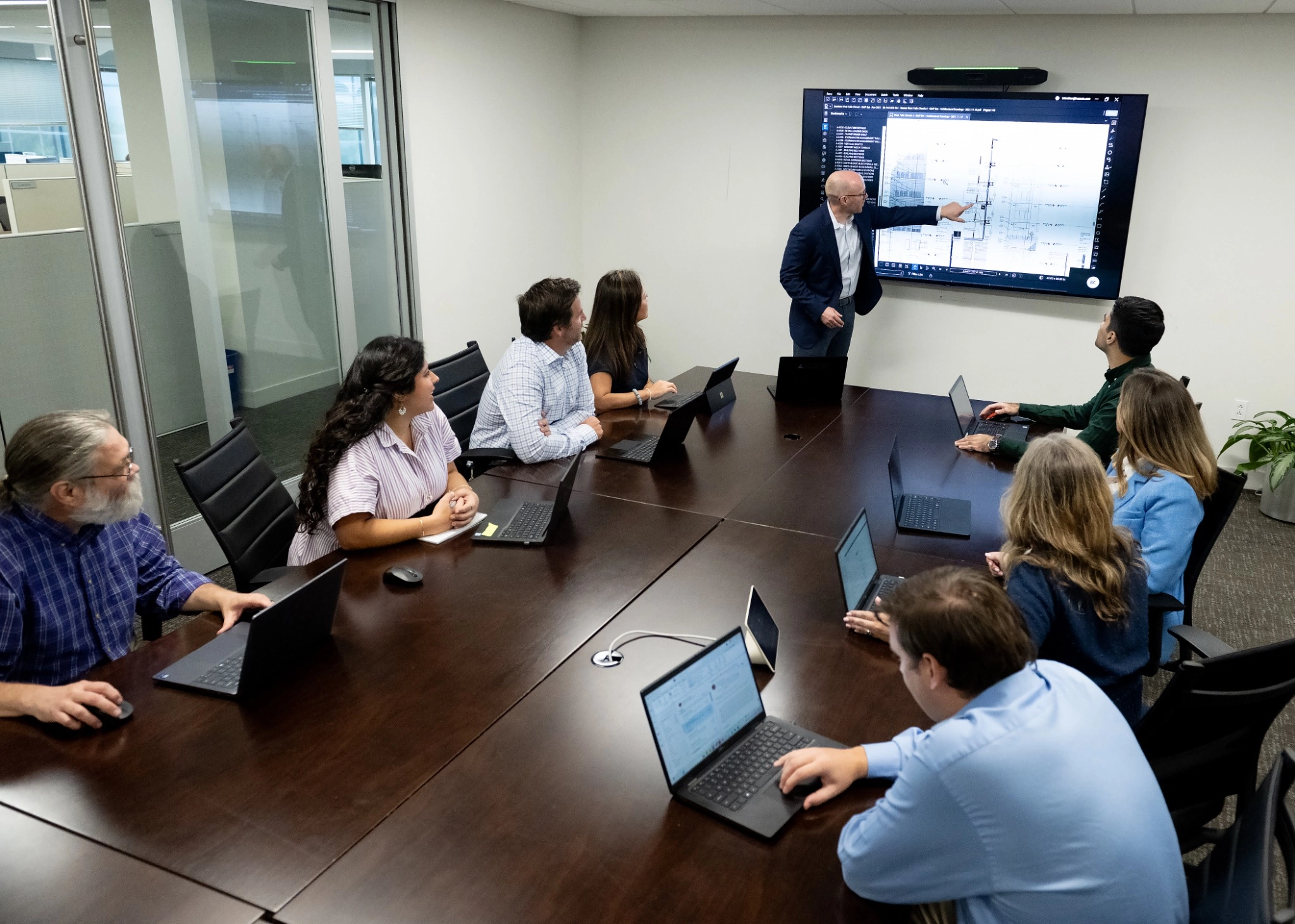 Group of people in a conference room engaged in a meeting.
