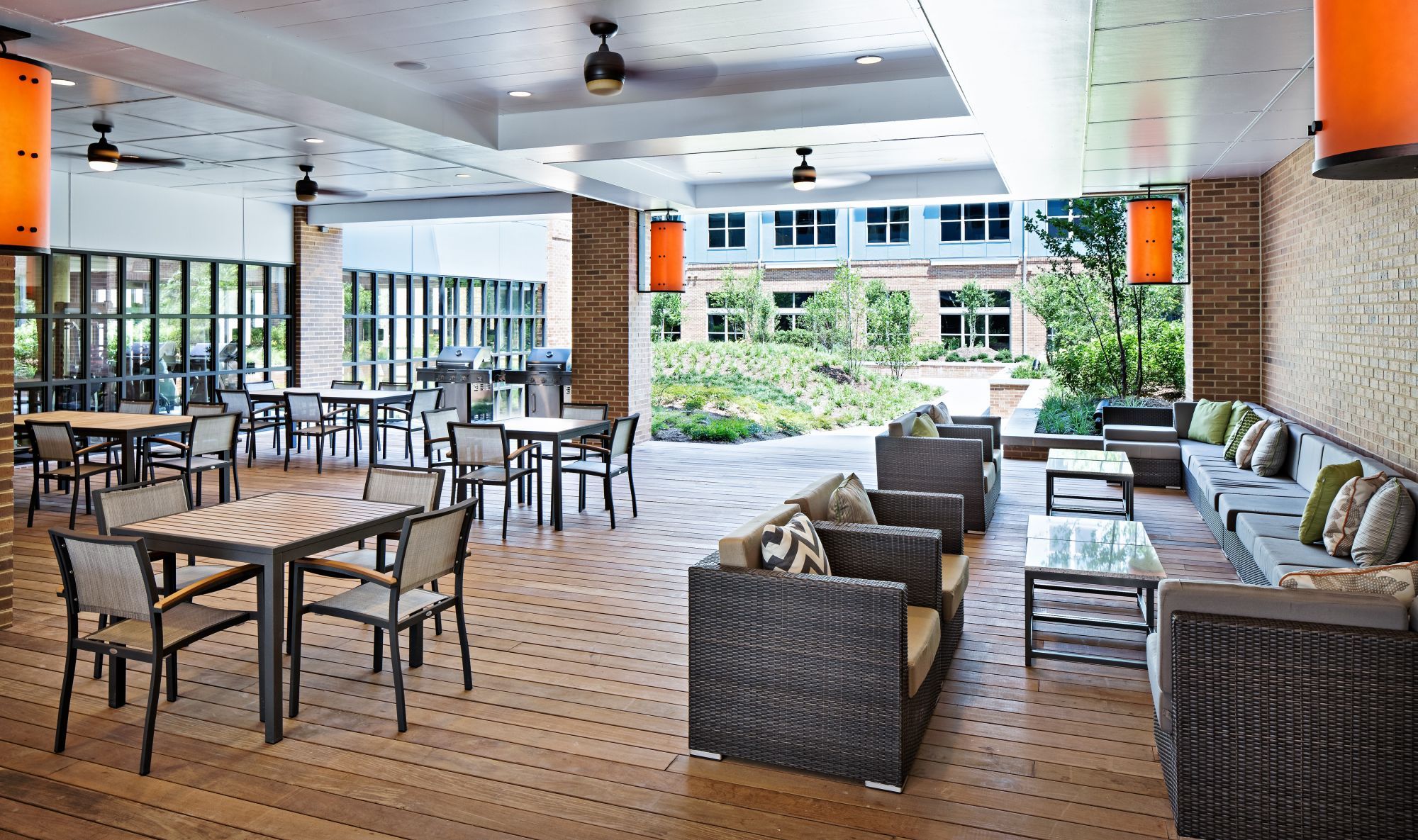 Outdoor seating area with tables, chairs, and modern decor.
