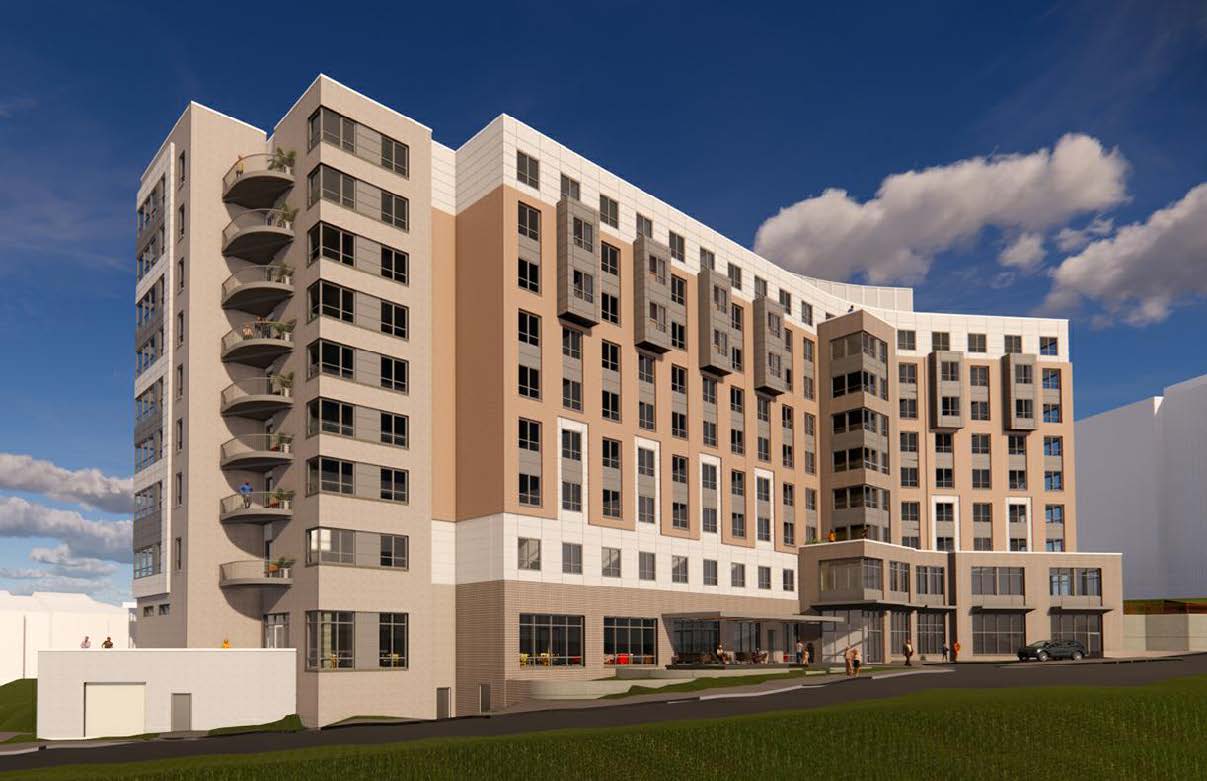 Modern multi-story building with balconies and a landscaped entrance.