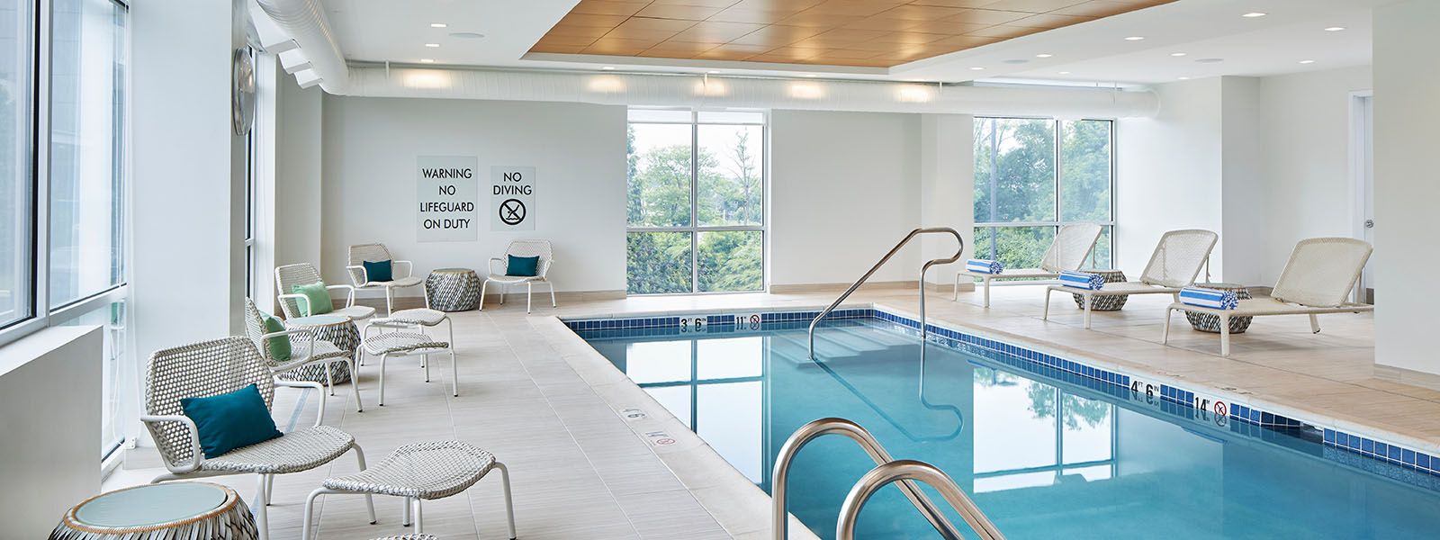 Indoor pool area with natural light and modern seating.