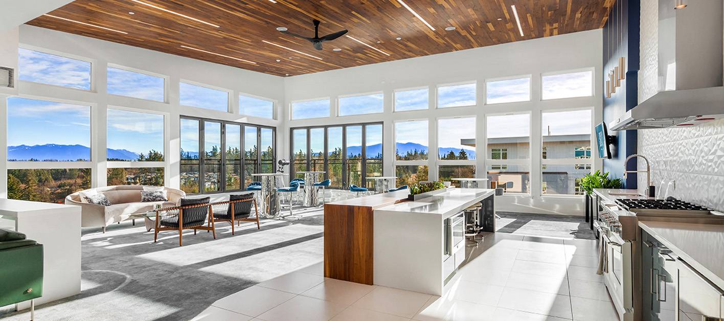 Bright, modern kitchen with large windows and mountain views.
