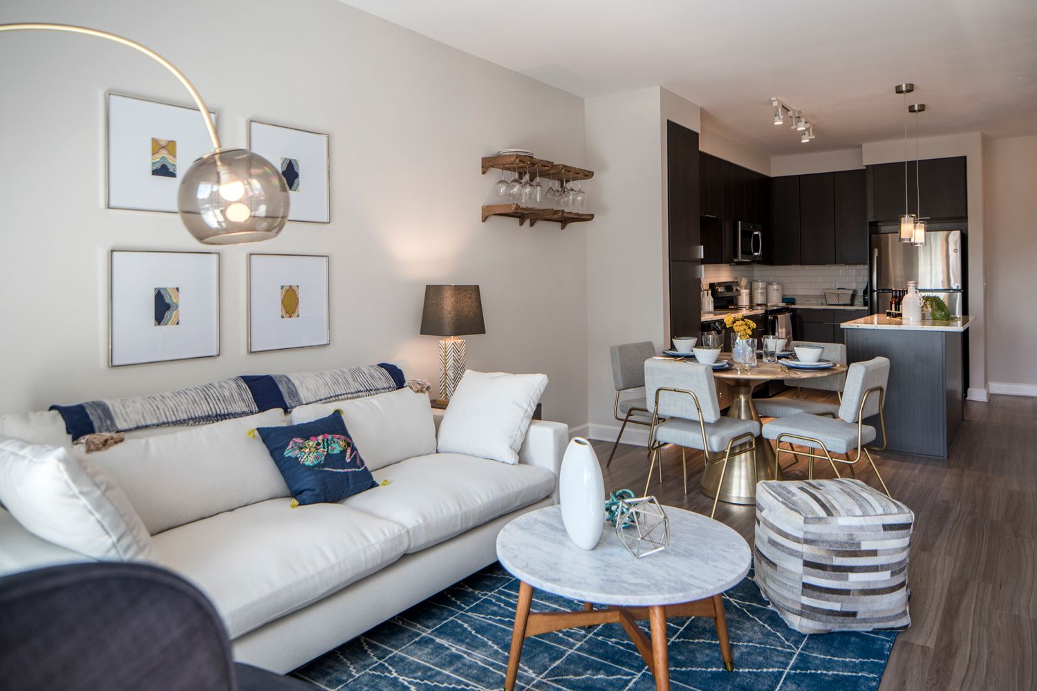 Modern living room with neutral tones, cozy sofa, and dining area in an open layout.
