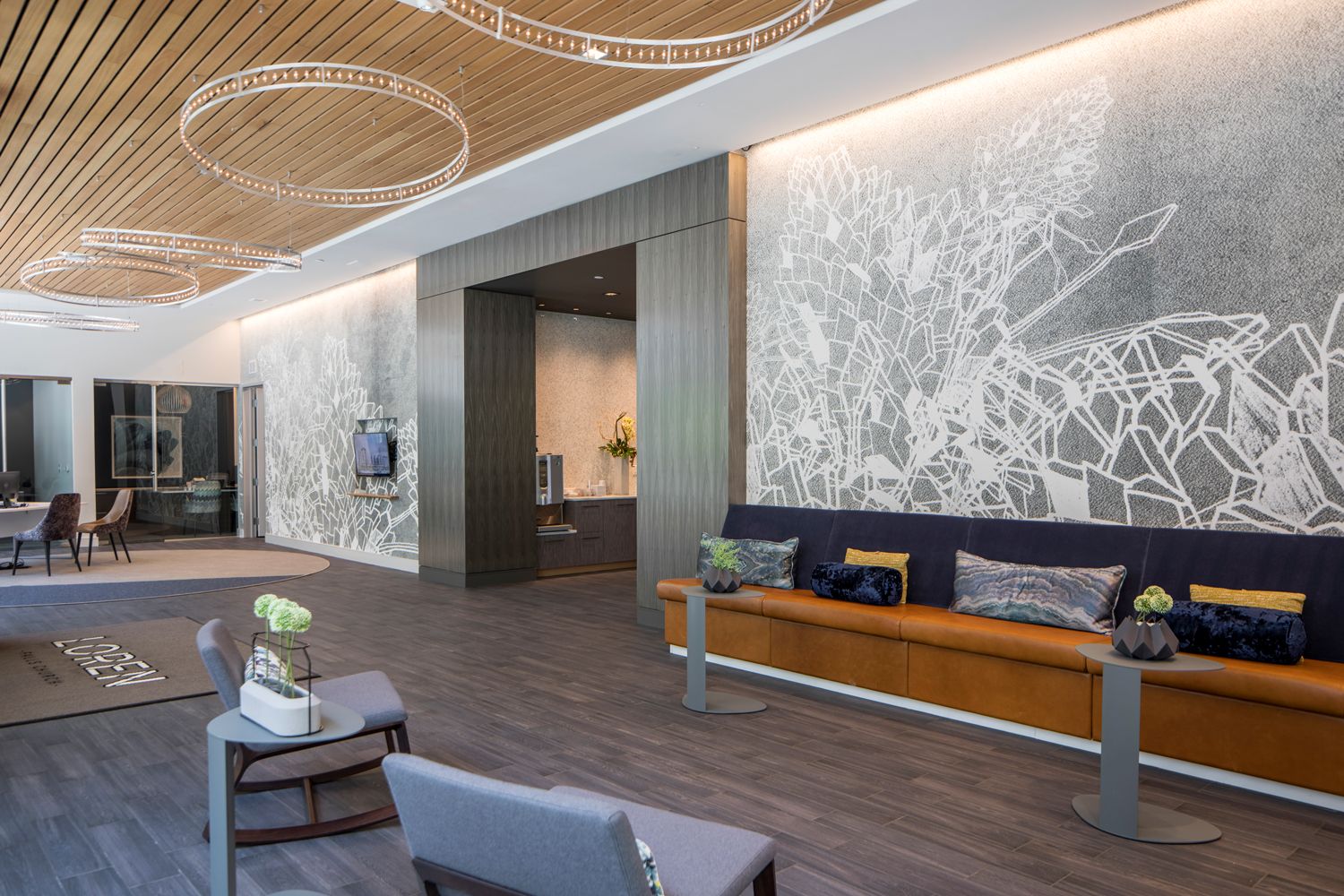 Modern lobby with wood accents, abstract wall art, and contemporary seating arrangements.
