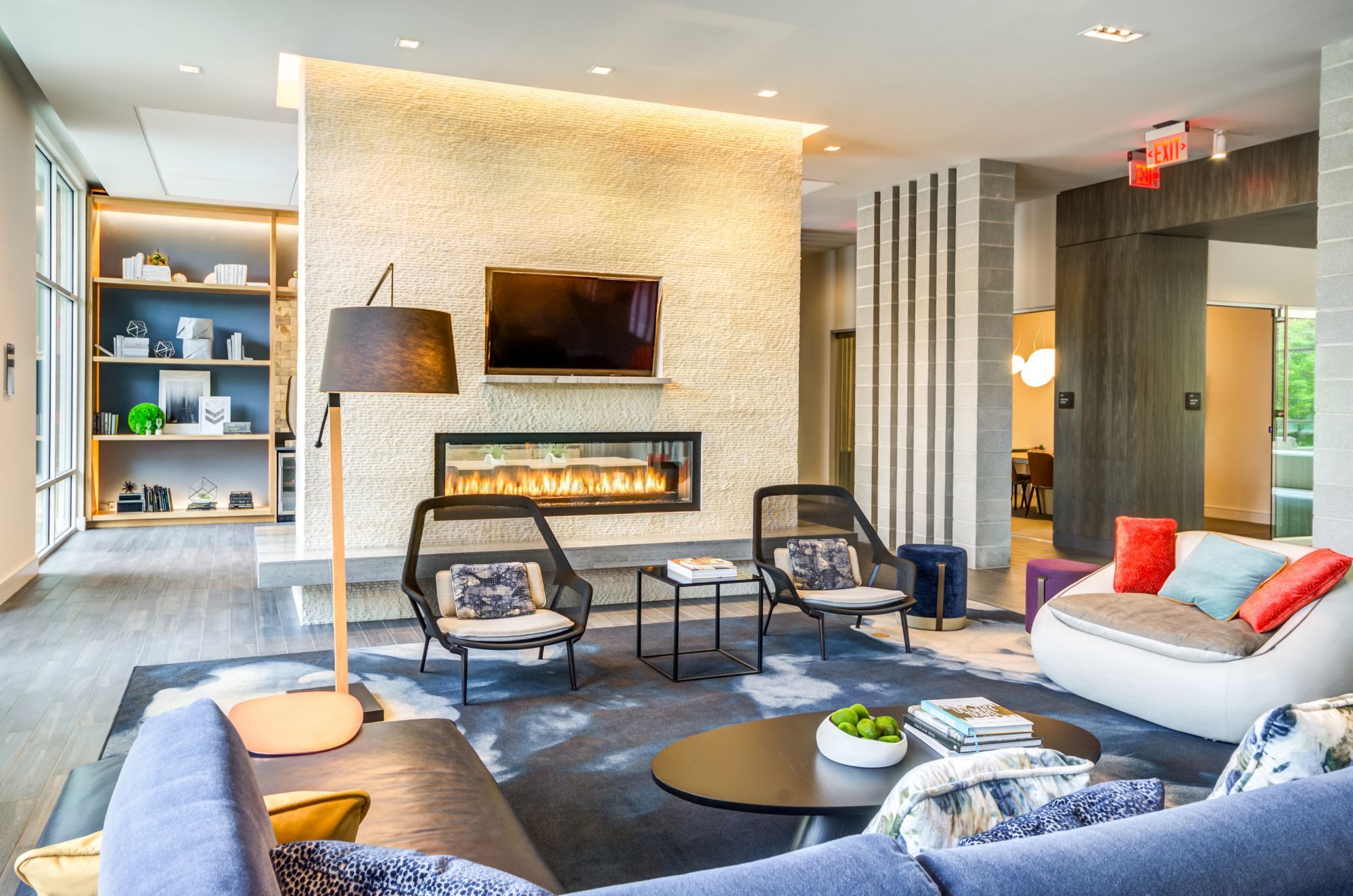 Modern lounge area with a fireplace, comfortable seating, and stylish decor.