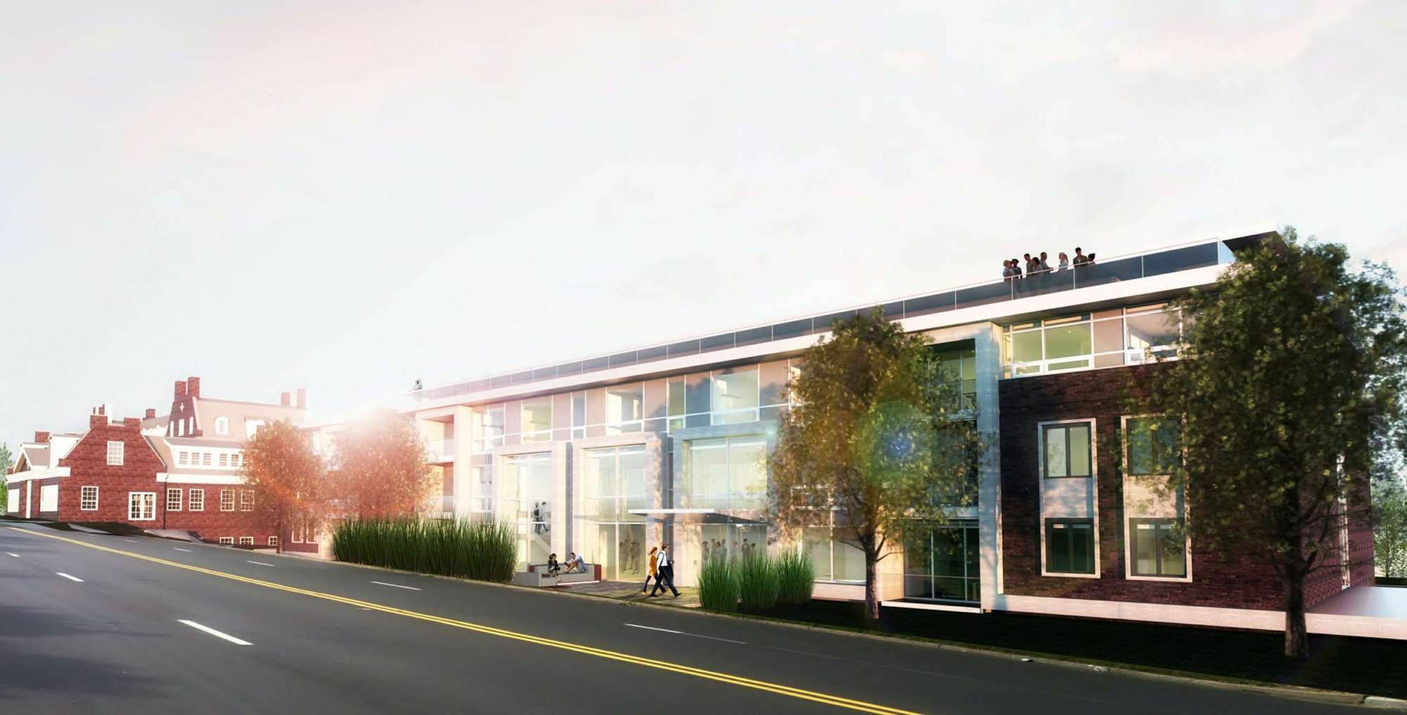 Modern building design with large windows and greenery, set along a city street.