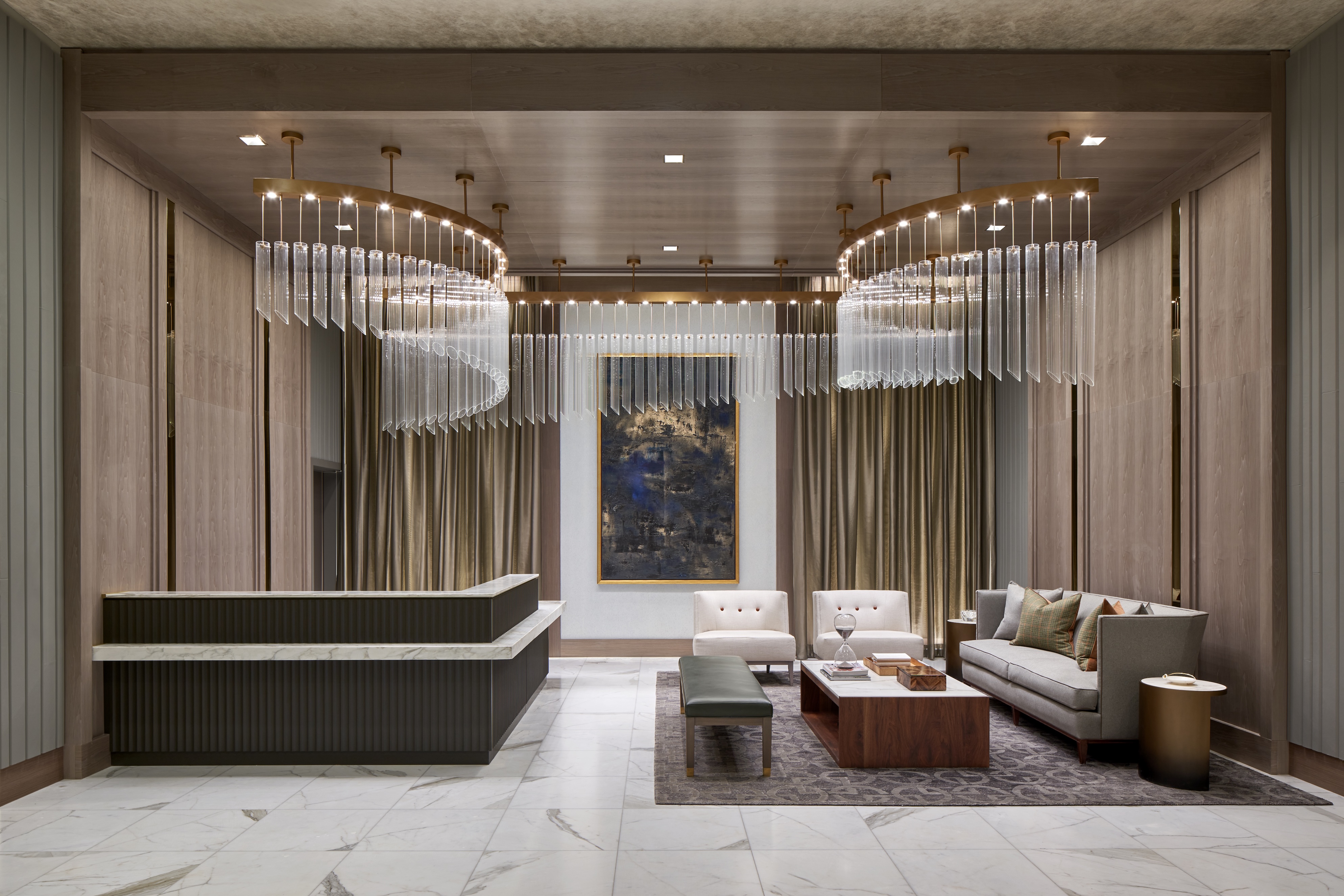 Modern lobby with elegant furnishings and chandeliers.