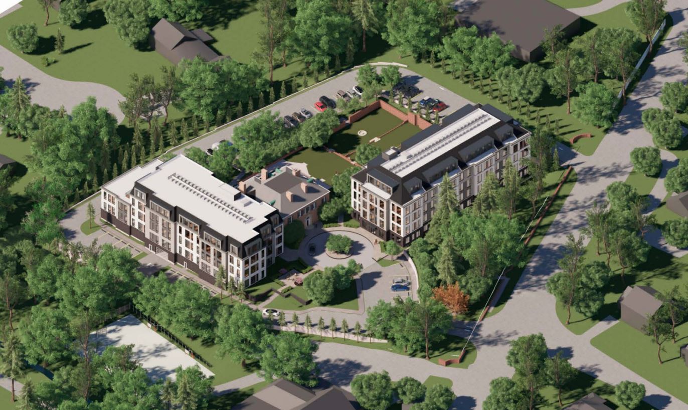 Aerial view of a modern building complex with green spaces.