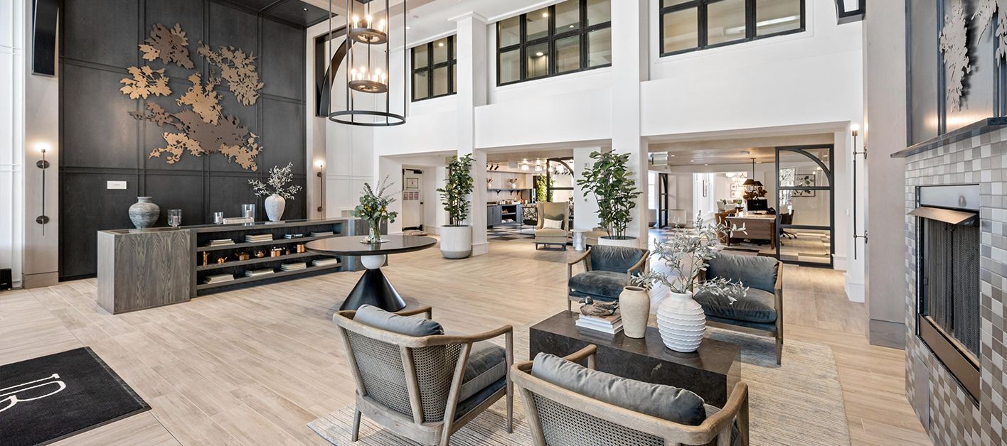 Modern lobby with seating, art, and plants.