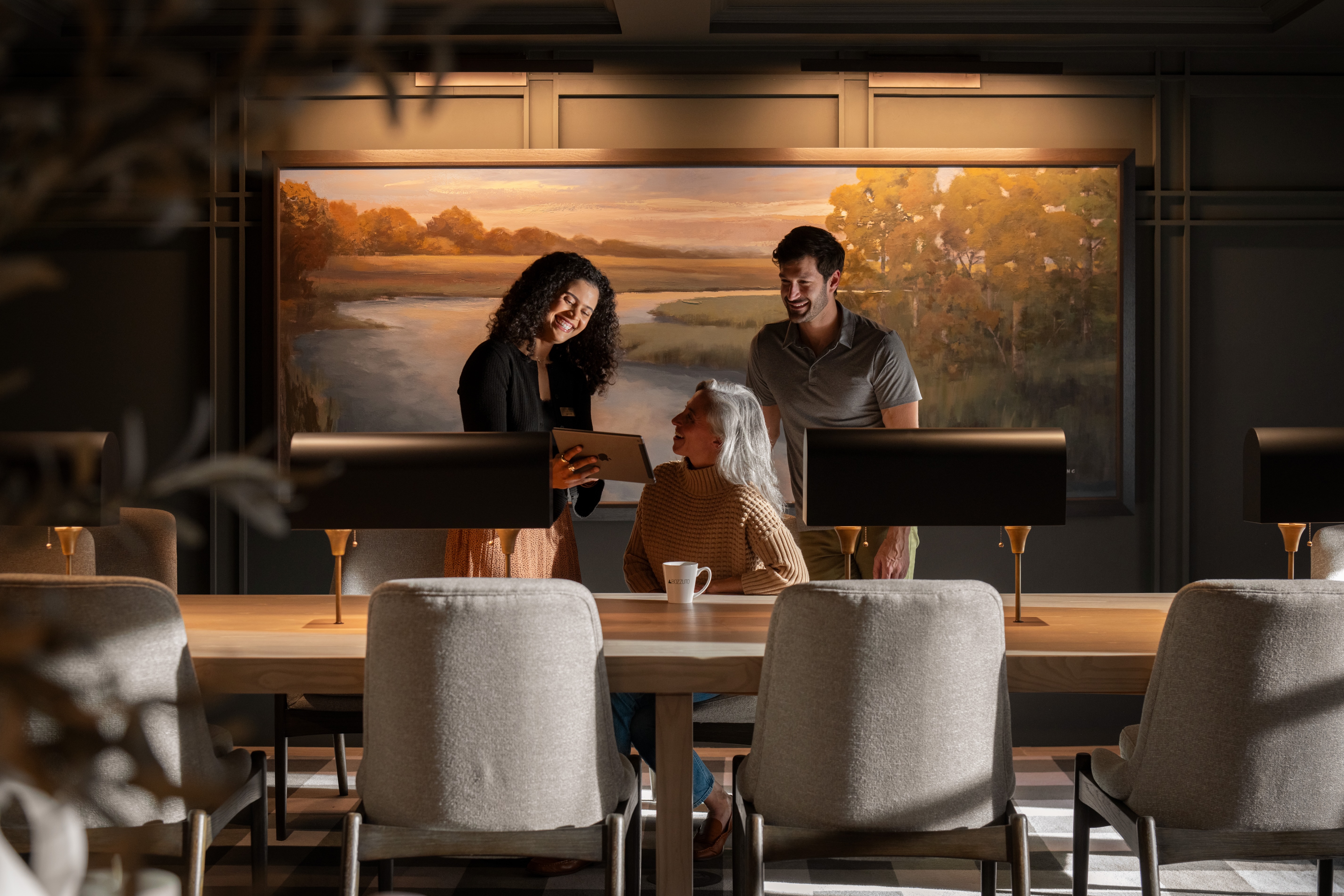 A woman and a man interacting with a child at a modern table.