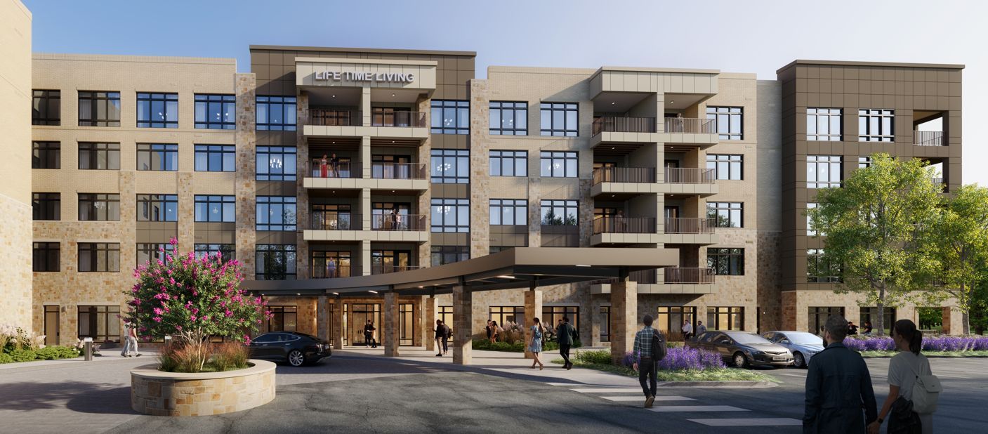 Modern multi-story building with entrance and landscaped surroundings.