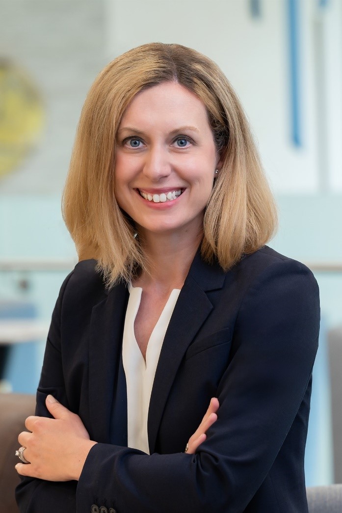 Professional portrait of Shelagh Anderson smiling, dressed in a blazer, with a neutral background.