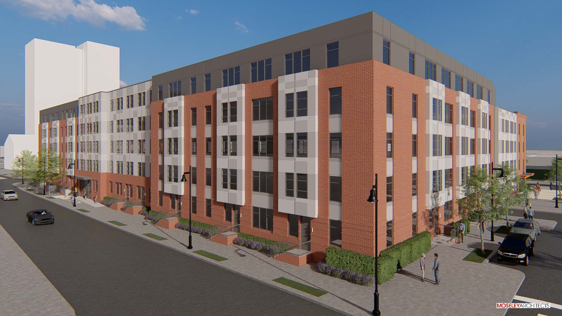 Modern multi-story building with brick and white façade, situated on a city street.