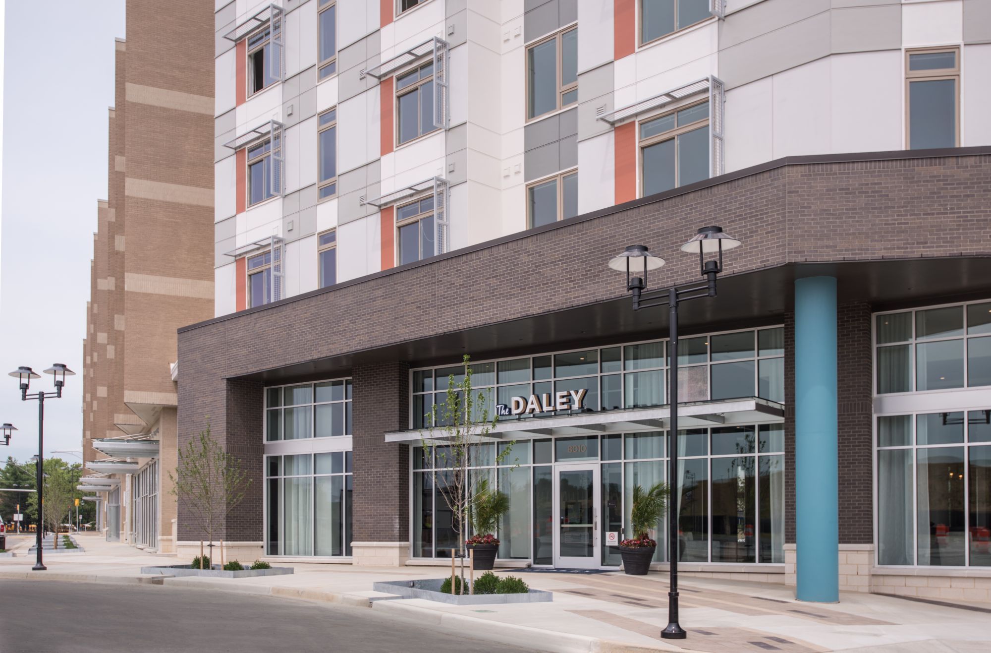 Modern building exterior with large glass entrance and colorful architectural details.