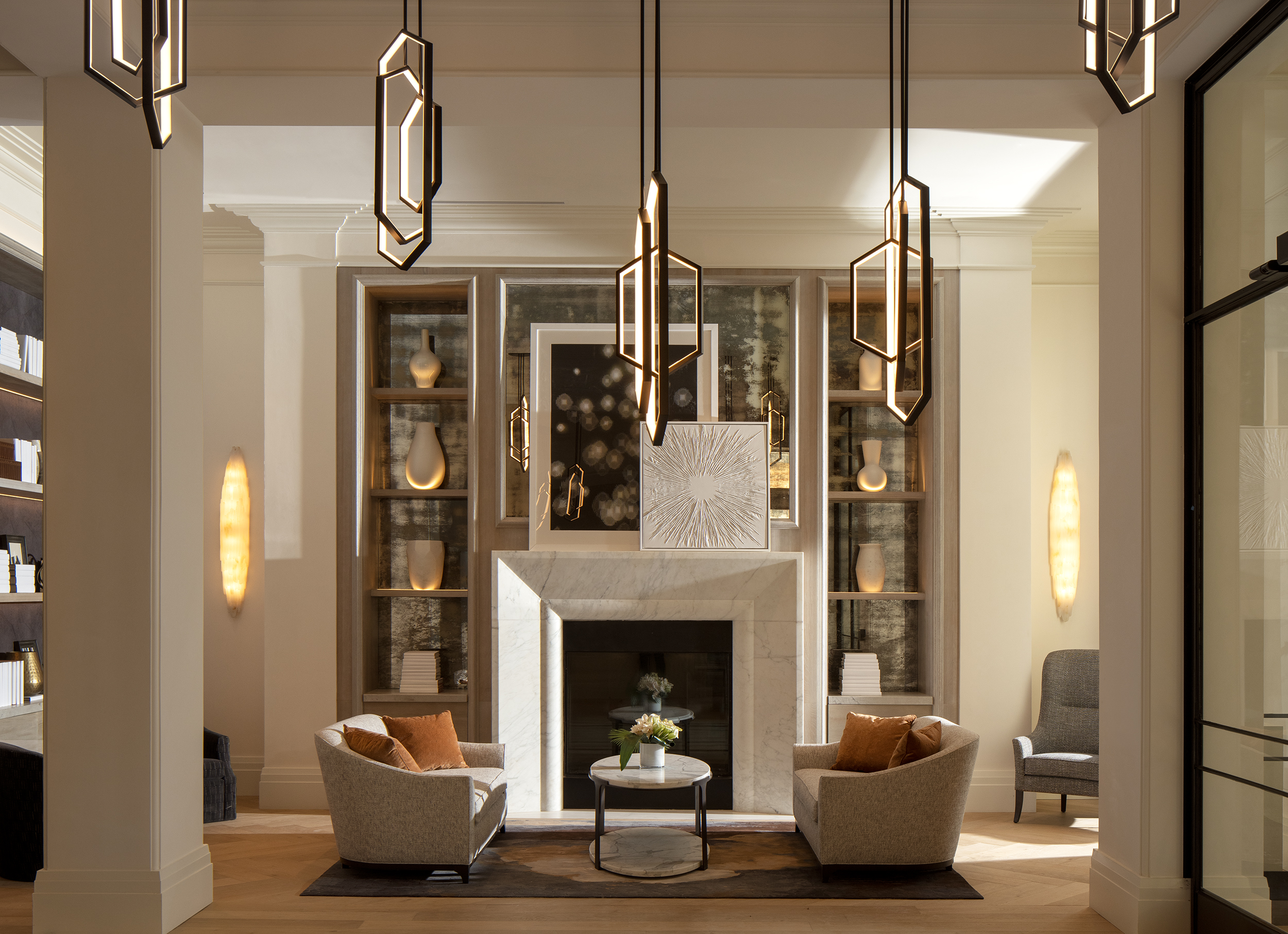 Modern living room with two chairs, a coffee table, and decorative lighting.