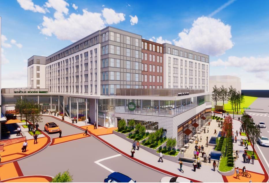 Modern hotel with multiple stories, outdoor spaces, and people in a vibrant urban setting.