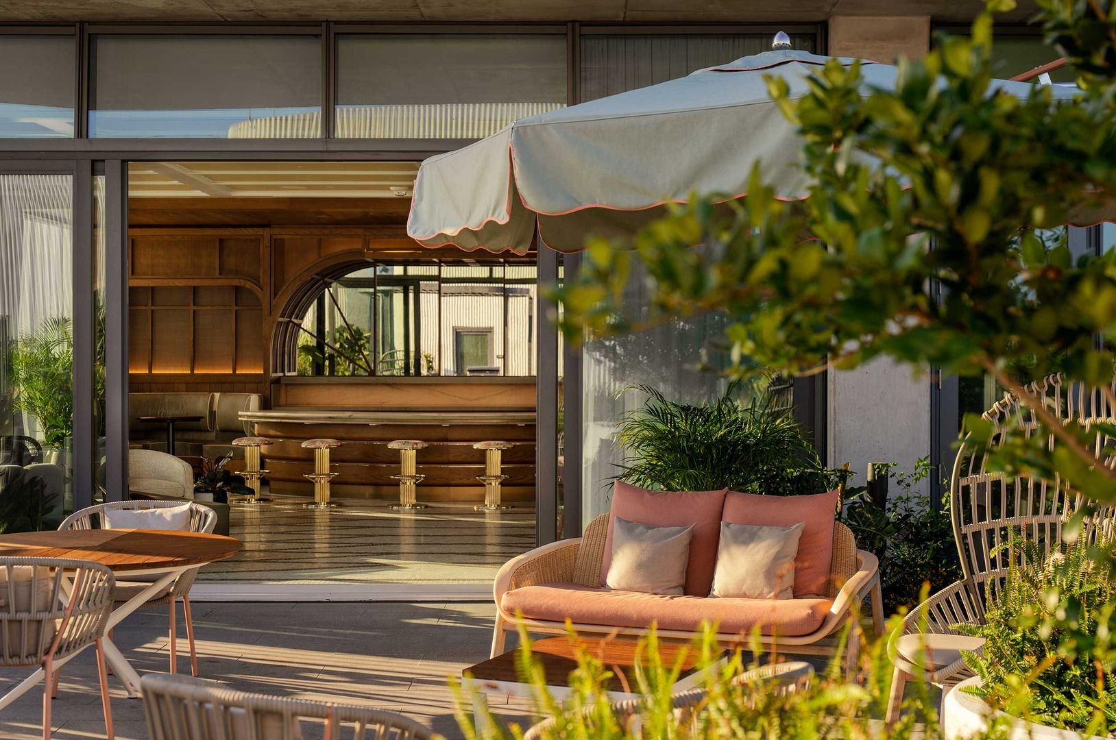 Modern patio with seating area and large open windows.