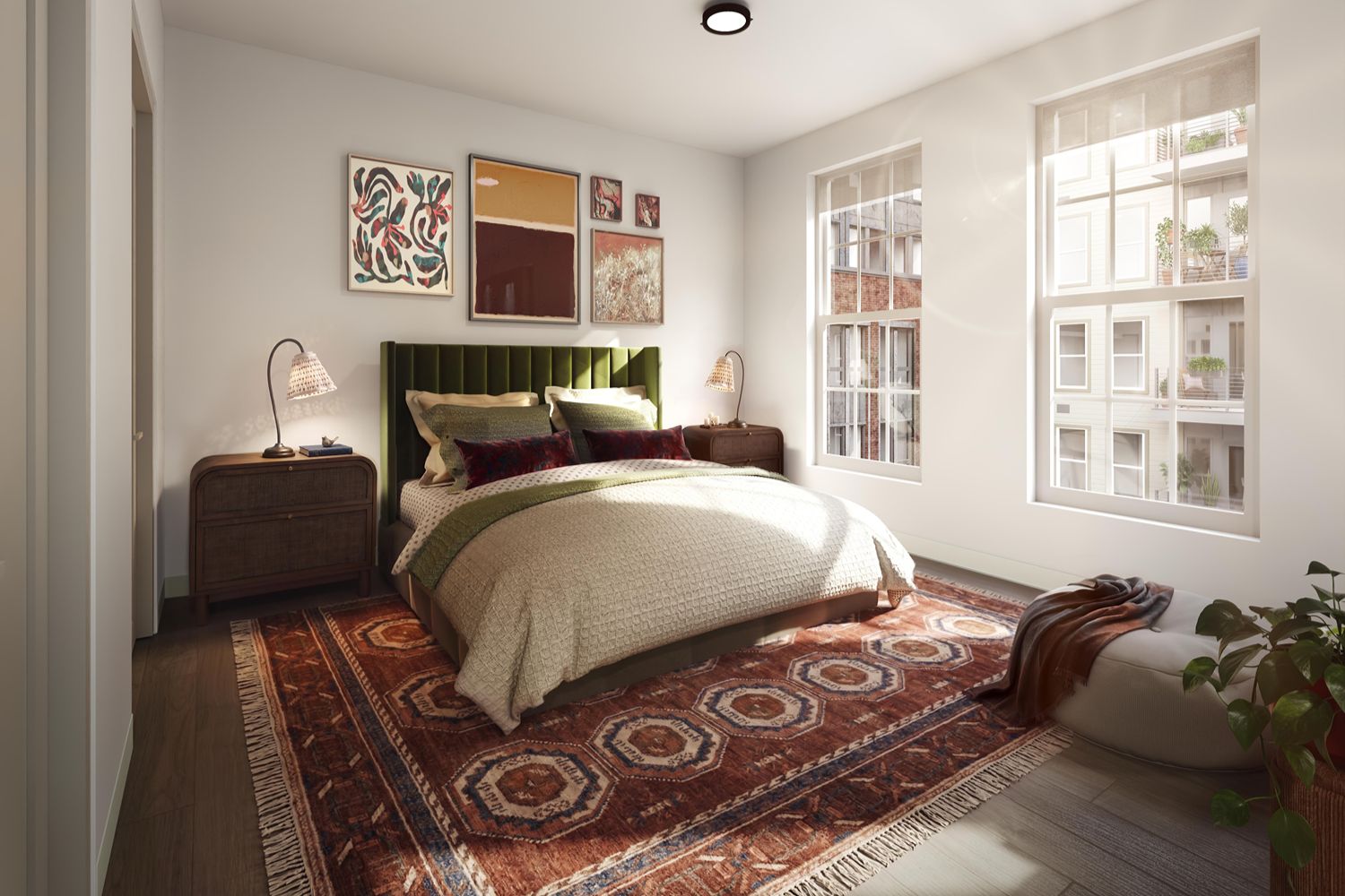 A cozy bedroom with green velvet headboard and decorative paintings.