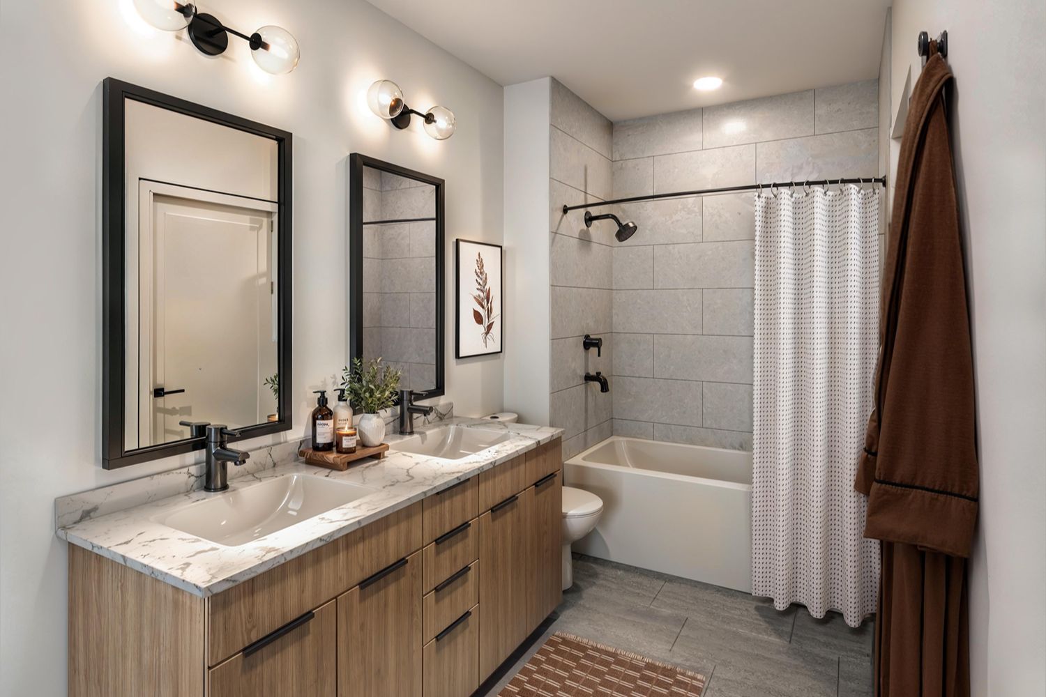 Modern bathroom with double sinks and a shower/tub combo.