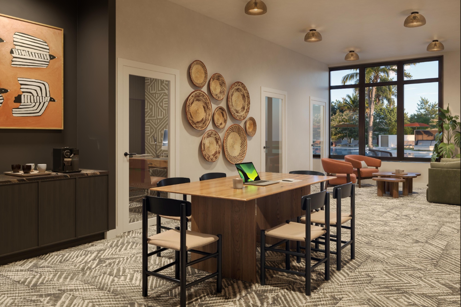 Modern communal space with a large table, chairs, and decorative wall plates.