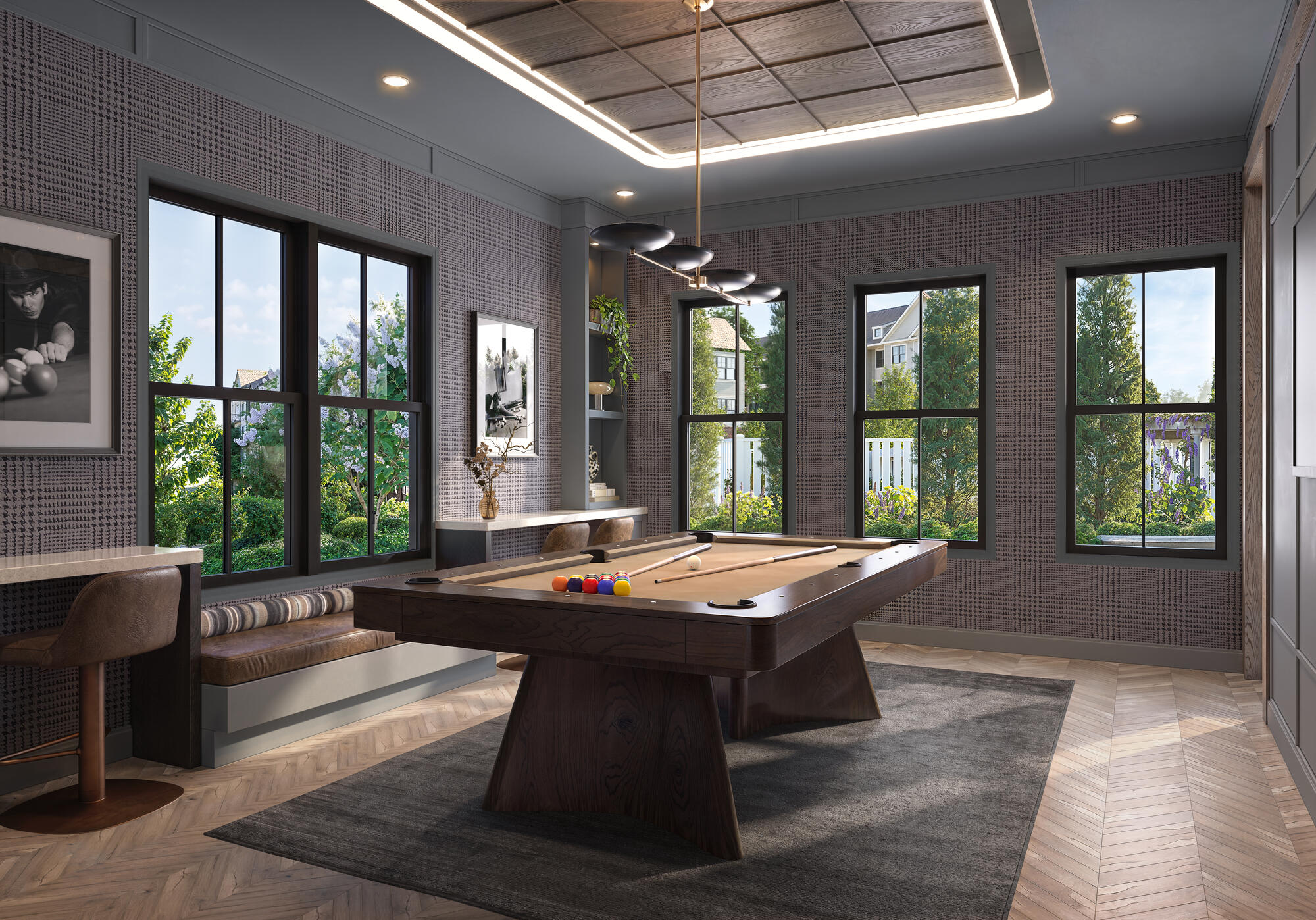 A modern clubroom with billiards table with brown felt and resident lounge seating