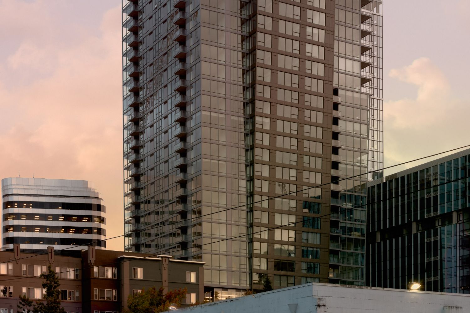 Kinects Tower Apartments illuminated by a sunset glow.