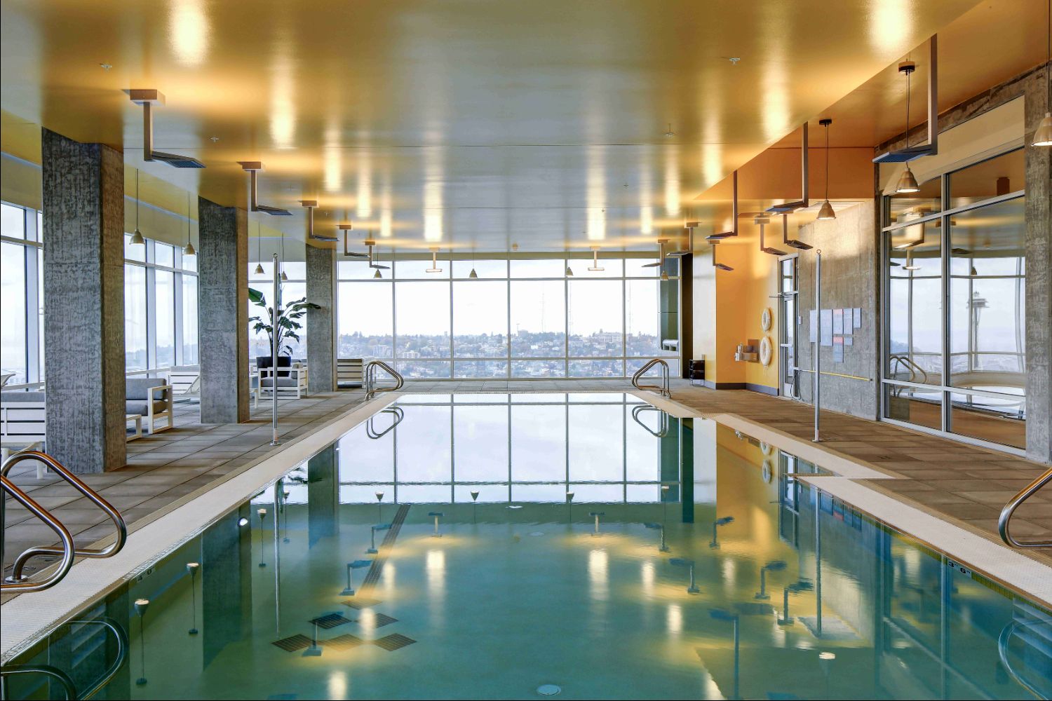 Indoor pool area at Kinects Tower Apartments with large windows and modern design.