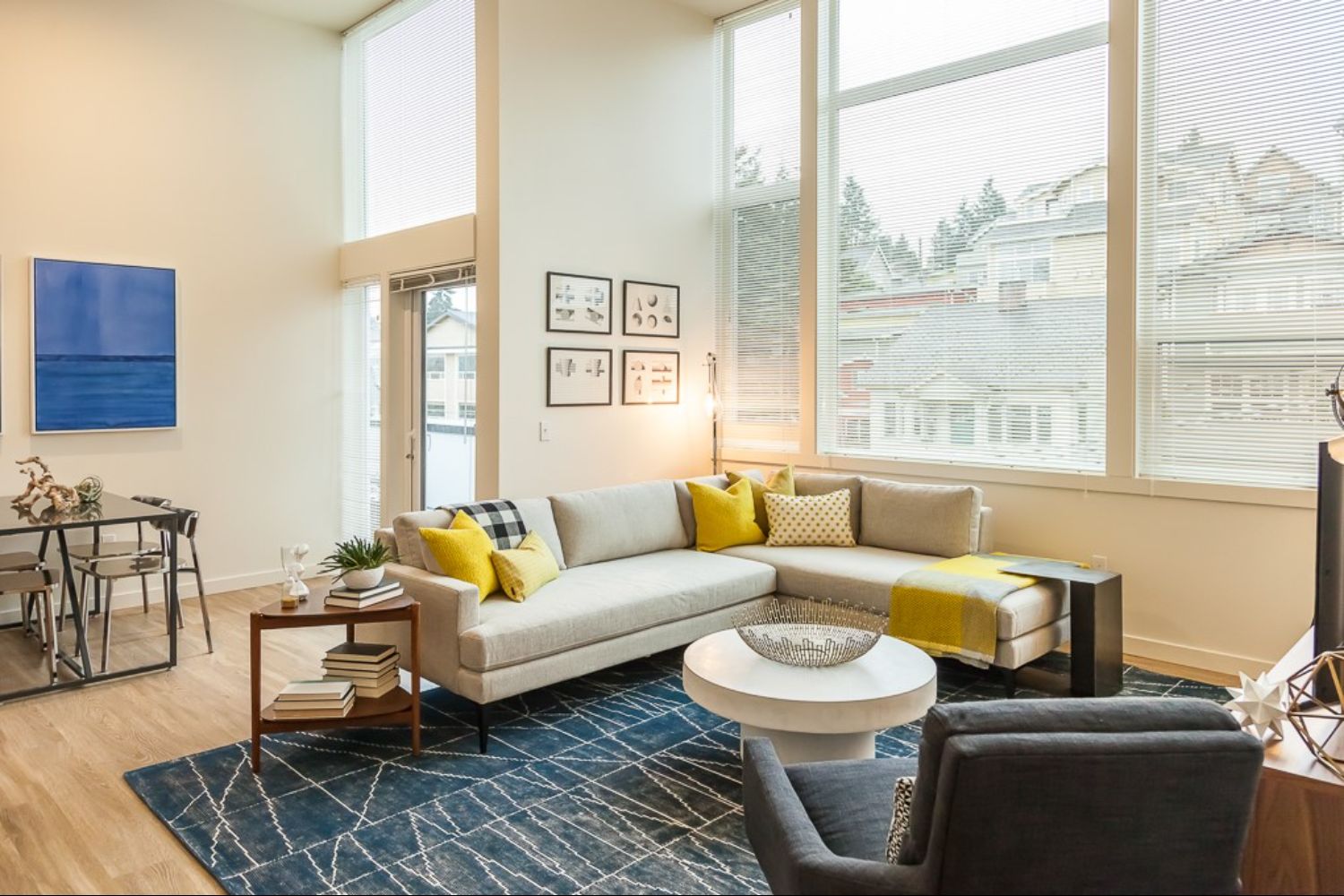 Modern living room with large windows and stylish furniture.