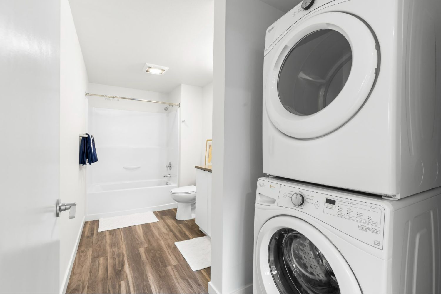 Laundry area with washer and dryer in a bathroom at Heron Flats and Lofts.