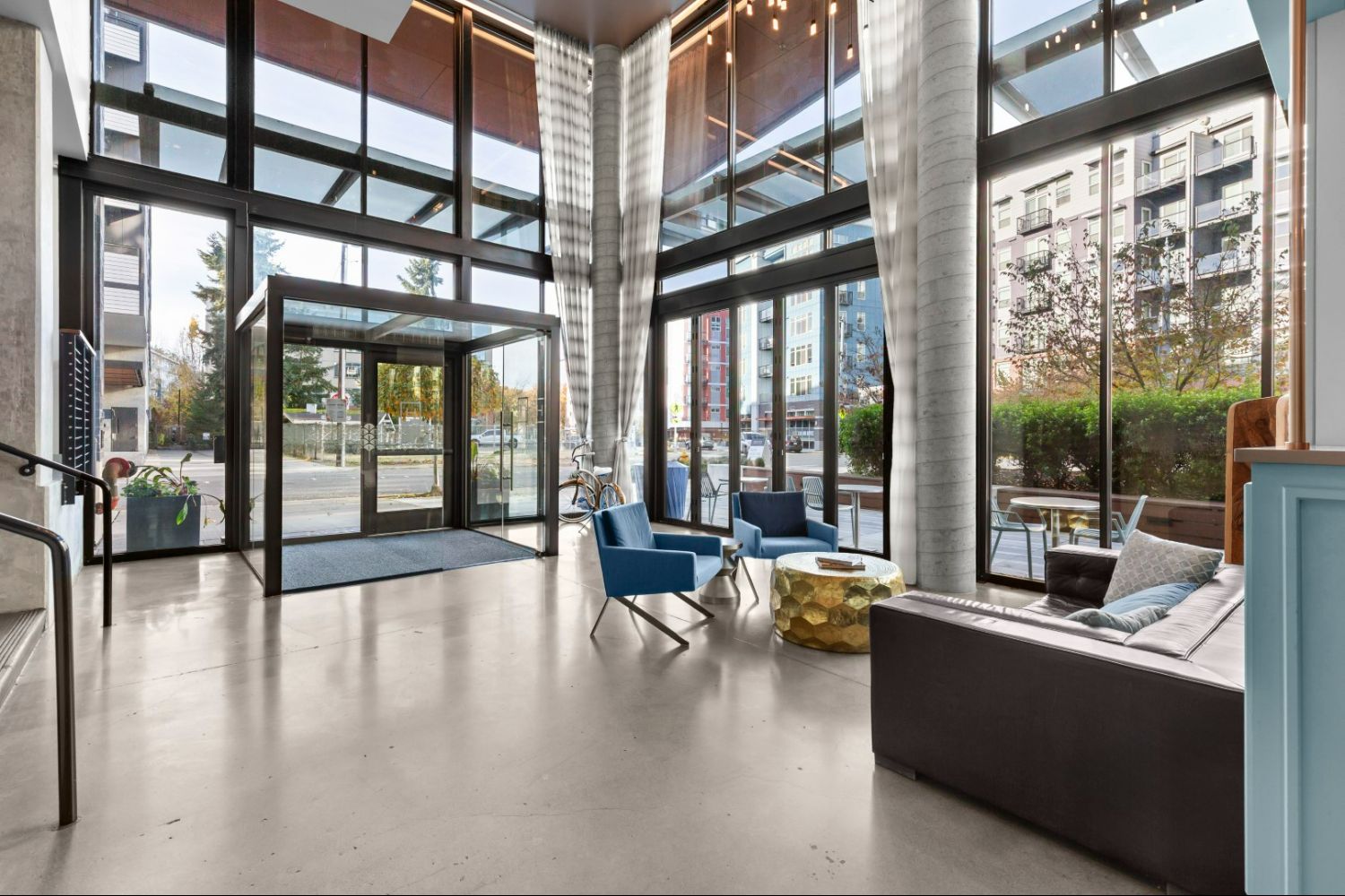 Lobby of Heron Flats and Lofts with large windows and comfortable seating.