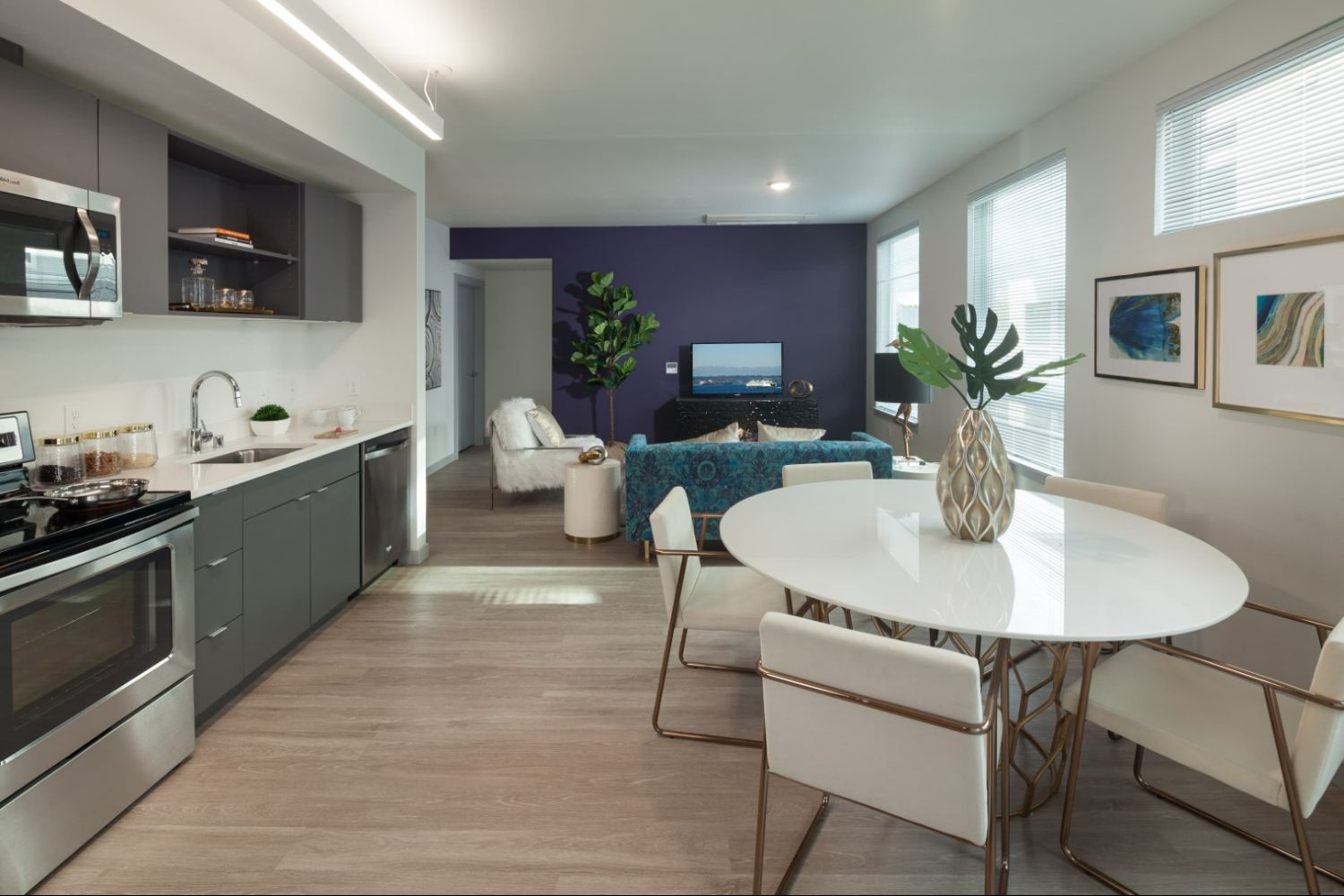 Open layout living space at Heron Flats and Lofts with kitchen, dining, and living spaces.