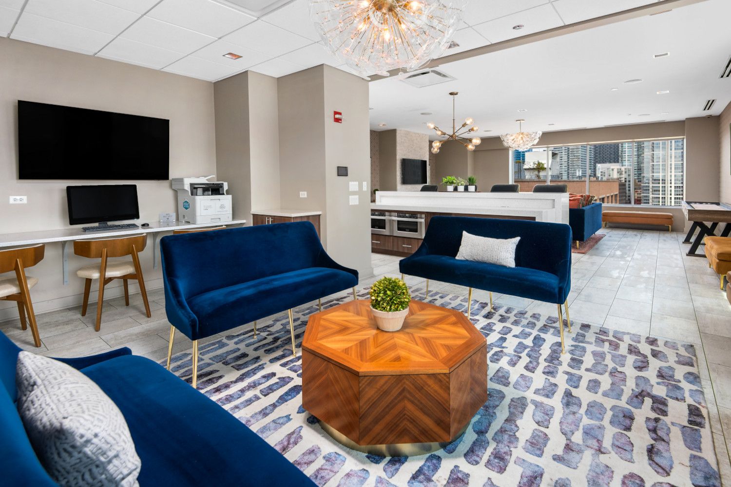 Modern lounge area with blue seating, a wooden table, and a contemporary decor.