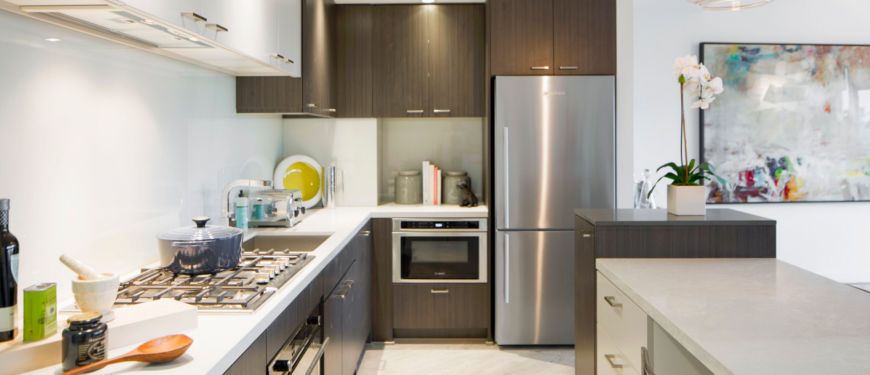 Designed for both beauty and function, the kitchen shows off sleek, stylish efficiency while concealing essential utility and features.