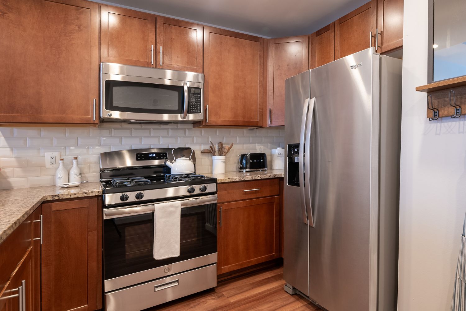 Gourmet kitchens with stainless steel appliances, granite countertops, and cherry wood cabinets.