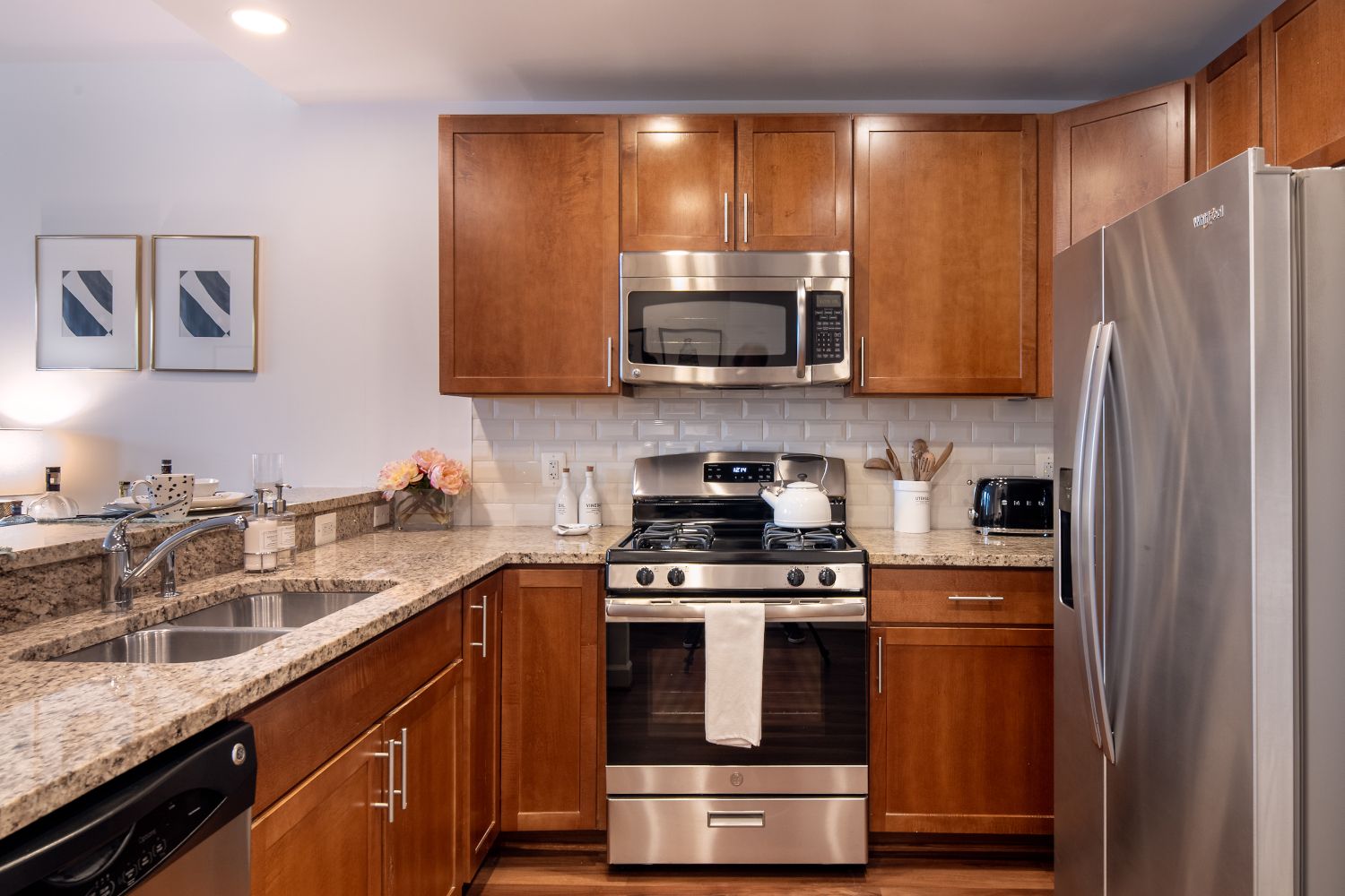 Gourmet kitchens with stainless steel appliances, granite countertops, and cherry wood cabinets.