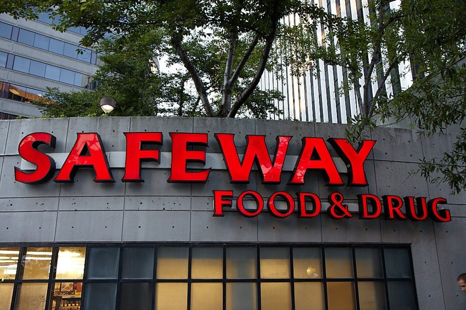 Signage for Safeway Food & Drug store in a city setting.